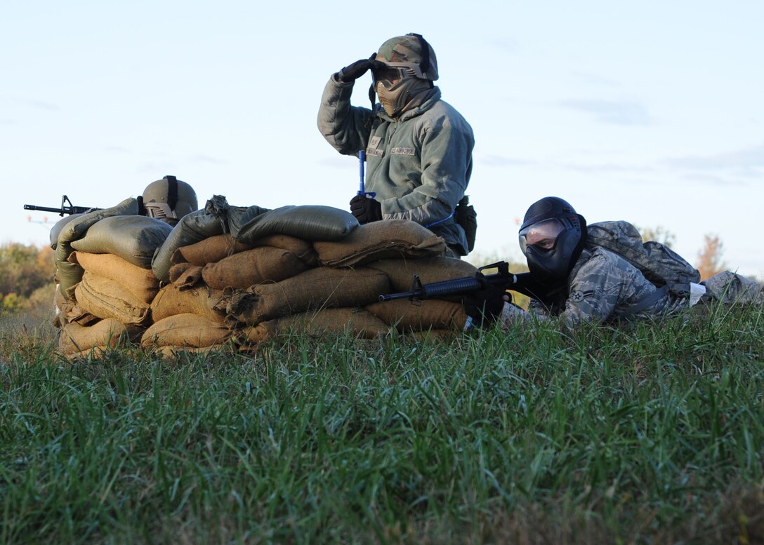 Staff Sgt. Matt Bargas, 744th Communications Squadron global information gird technician; Tech. Sgt. Mark Abraham, 844th Communication Group knowledge operations NCO in charge (observing); and Airman 1st Class Carl Free, 744th CS radio frequency transmissions systems technician (prone), take cover in a defensive fighting position during the annual 844th Communications Group Warrior Day Competition on Oct. 21 near Freedom Park. (U.S. Air Force photo/Airman 1st Class Bahja J. Jones)