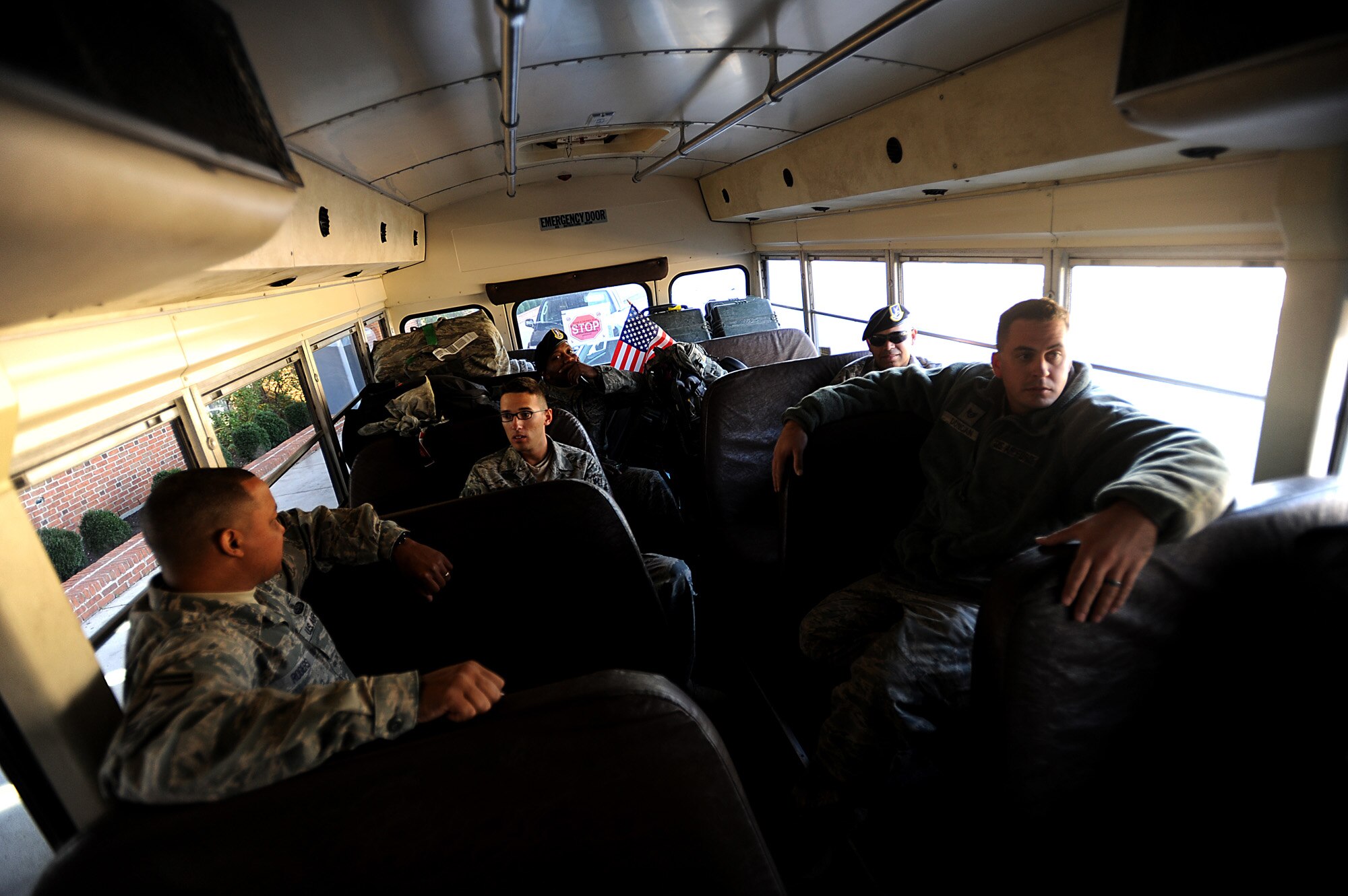 Members from the 633rd Security Forces Squadron, which is at Joint Base Langley-Eustis, Va., ride back to base on a bus after welcoming home and picking up Staff Sgt. John Duncan, Senior Airmen Kristian Robles Cruz and Amber Boyd, and Airman Basic Joseph Wesley from the airport Nov. 2, 2011. The four Airmen were deployed to Joint Base Balad, Iraq. About 10 633rd SFS members are still deployed in Iraq, but they are scheduled to return later this month, although more are expected to deploy to Afghanistan in the next few months. (U.S. Air Force photo/Master Sgt. Jeremy Lock)