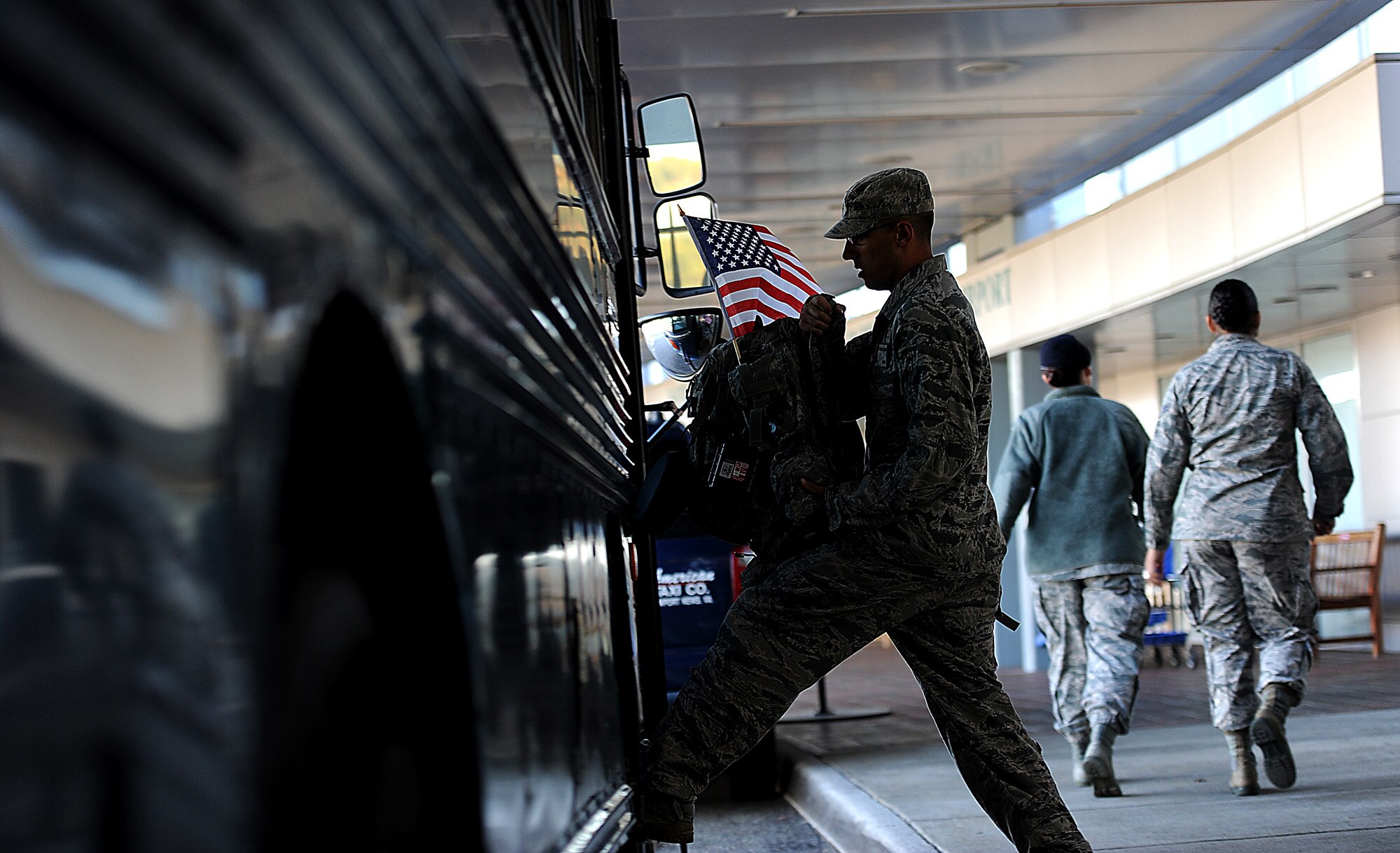 Airman Basic Joseph Wesley, from the 633rd Security Forces Squadron out of Joint Base Langley-Eustis, Va., gets on a bus after being greeted at the Newport News, Va., airport by family and coworkers Nov. 2, 2011. He was among about 20 633rd SFS members who returned to JB Langley from deployment with the 332nd Expeditionary Security Forces Squadron at Joint Base Balad in the past week. (U.S. Air Force photo/Master Sgt. Jeremy Lock)
