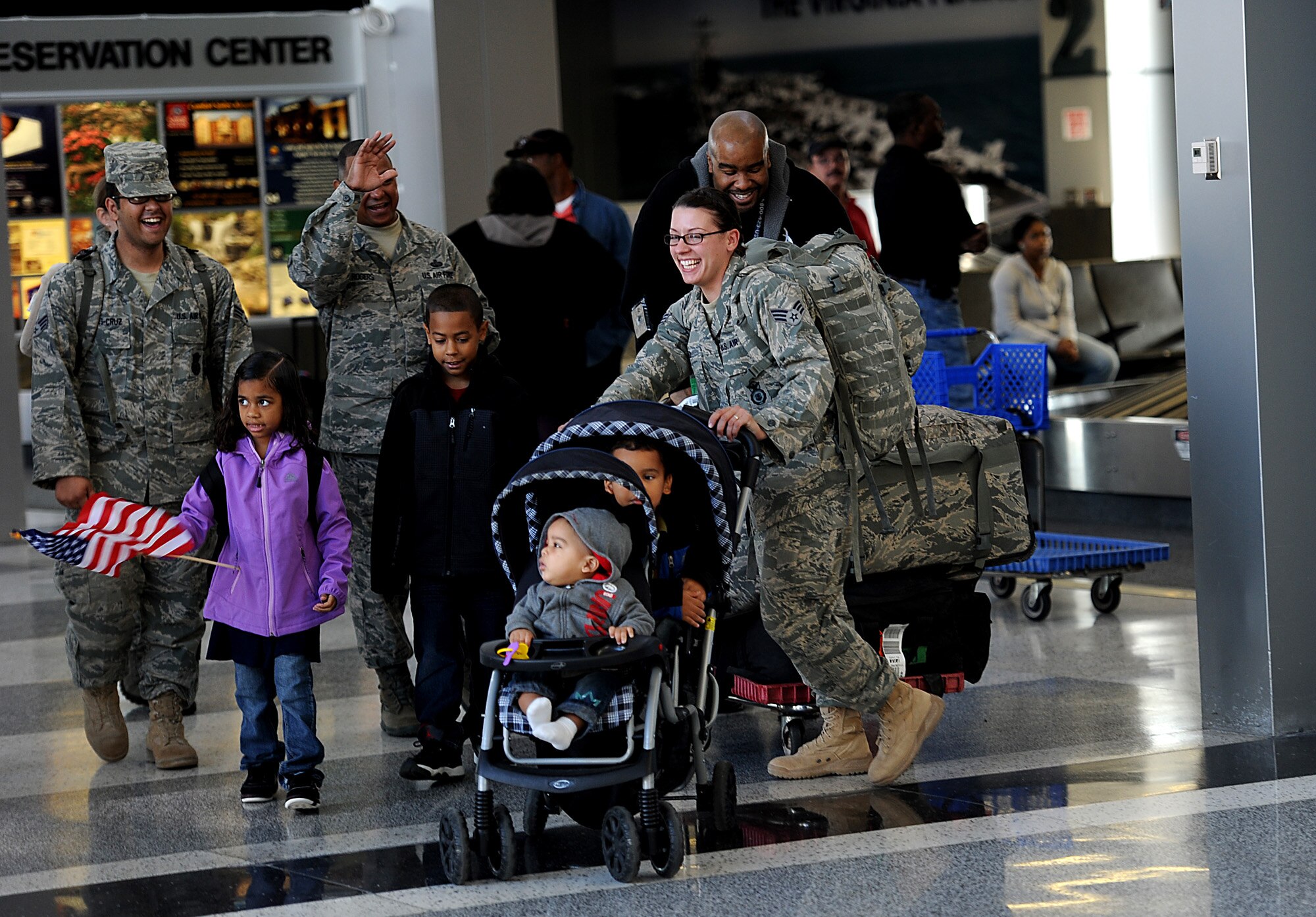 Senior Airmen Kristian Robles Cruz and Amber Boyd from the 633rd Security Forces Squadron, which is at Joint Base Langley-Eustis, Va., are greeted at the Newport News, Va., airport by family and coworkers Nov. 2, 2011 . The two were part of a group of Airmen that deployed to Joint Base Balad, Iraq, in June, but returned a couple of months early after President Obama announced the withdrawal of all U.S. troops from Iraq by the end of the year. (U.S. Air Force photo/Master Sgt. Jeremy Lock)