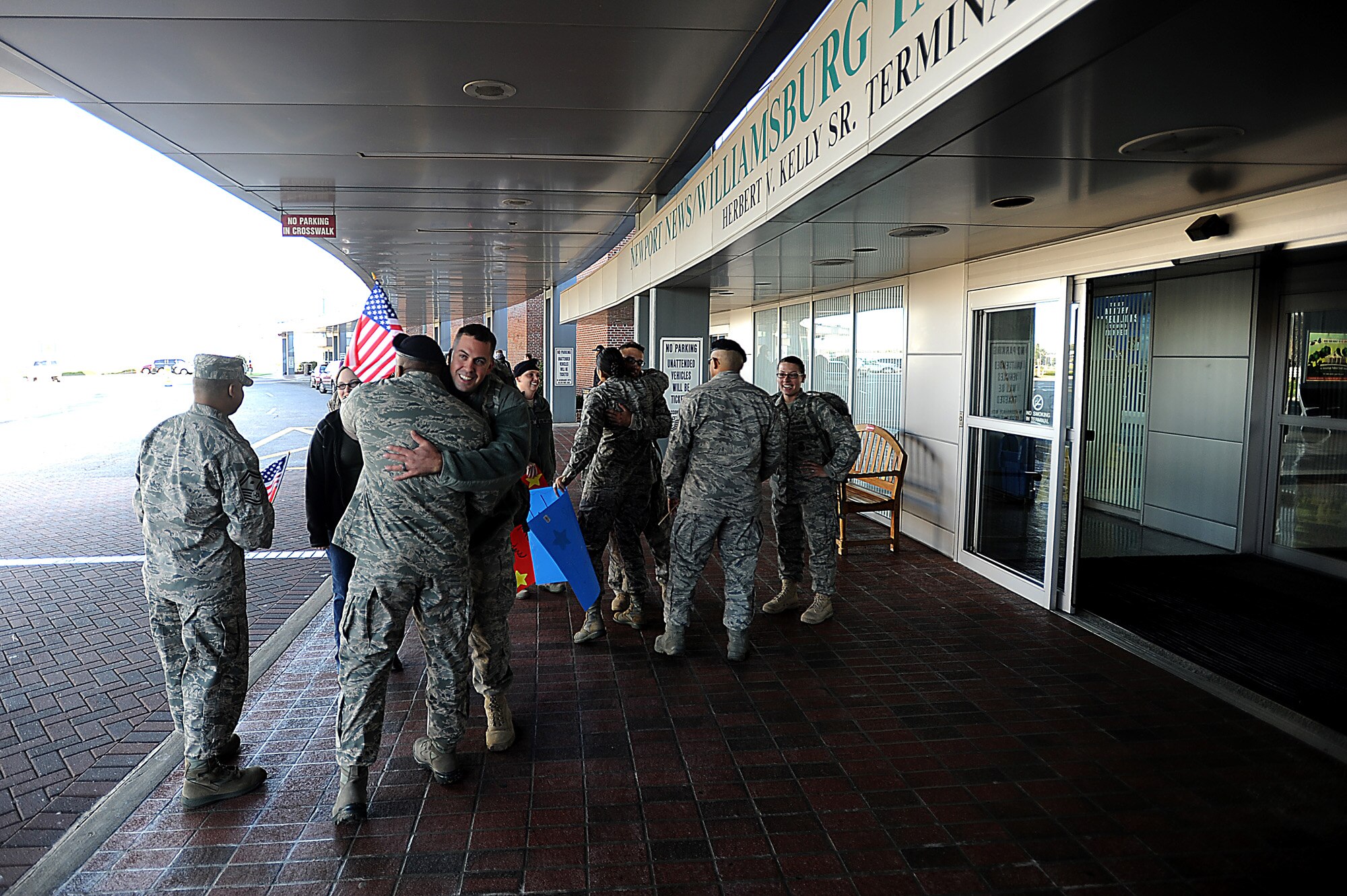 Members from the 633rd Security Forces Squadron welcome home Staff Sgt. John Duncan, Senior Airmen Kristian Robles Cruz and Amber Boyd, and Airman Basic Joseph Wesley on Nov. 2, 2011, at the Newport News, Va., airport. The four Airmen were among about 20 633rd SFS members who returned to Joint Base Langley-Eustis, Va., from deployment with the 332nd Expeditionary Security Forces Squadron at Joint Base Balad, Iraq, in the past week. (U.S. Air Force photo/Master Sgt. Jeremy Lock)