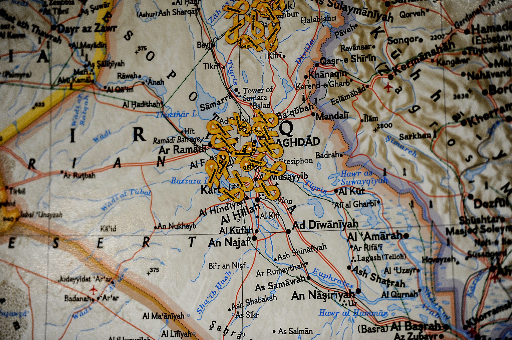 Yellow ribbons on a map represent where members from the 633rd Security Forces Squadron, which is at Joint Base Langley-Eustis, Va., are deployed Nov. 2, 2011.  Soon, Staff Sgt. John Duncan, Senior Airmen Kristian Robles Cruz and Amber Boyd, and Airman Basic Joseph Wesley will position their ribbons back stateside after returning from their recent deployment to Joint Base Balad, Iraq. (U.S. Air Force photo/Master Sgt. Jeremy Lock)