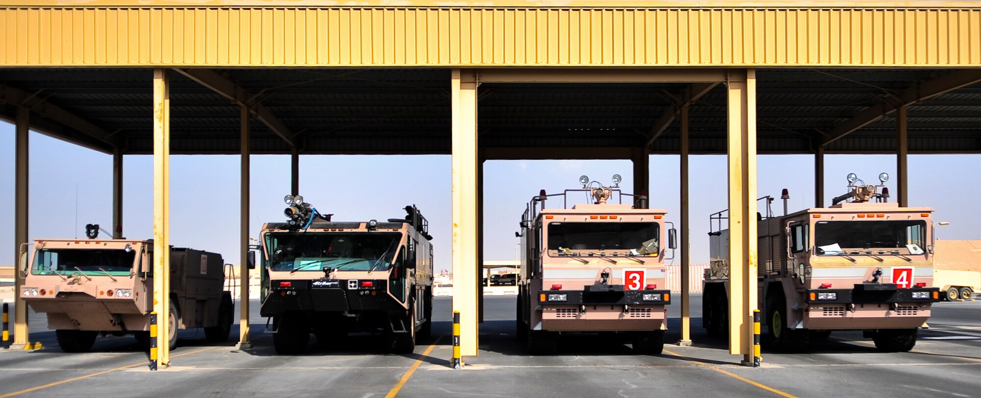 The 379th Civil Engineer Squadron fire department uses a variety of vehicles to respond to emergencies on the flightline at an undisclosed location in Southwest Asia. The department’s lineup includes (left to right): The Oshkosh P-19 Otis crash truck, the Oshkosk Striker P-19 crash truck, and the Oshkosh T3000 crash truck. The P-19 Otis holds 1,000 gallons of water, while the Striker can hold up to 1,500 gallons and the T3000 holds 3,000 gallons. (U.S. Air Force photo/Senior Airman Paul Labbe)