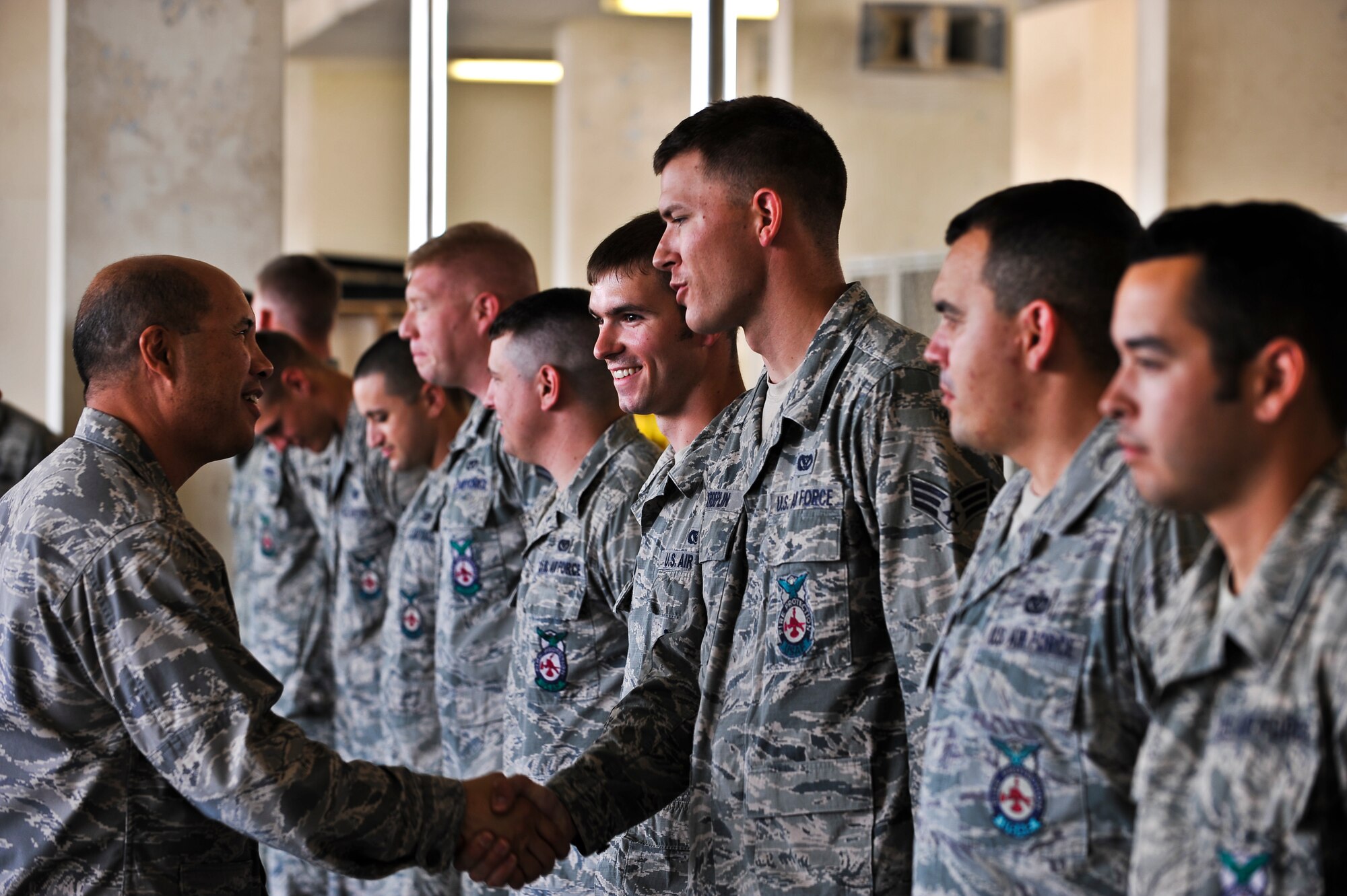 Col. Giovanni Tuck, 379th Air Expeditionary Wing commander, shakes hands with firefighters from the 379th Civil Engineer Squadron Nov. 2, 2011, at an undisclosed location in Southwest Asia. The commander makes frequent visits, called “Day in the Shoes,” to units around the base to get a firsthand look at Airmen and their missions. (U.S. Air Force photo/Senior Airman Paul Labbe)