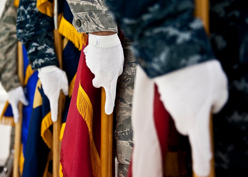 The newly-formed joint color guard team of 33rd Fighter Wing members waits to begin its first performance at a recent change of command ceremony at Eglin Air Force Base, Fla., Nov. 2. The joint color guard team members are:  Corpsman Sarah Lambert, Petty Officer 2nd Class James Peters, Senior Airman Chad Walker, Petty Officer 1st Class Jack Bauer, Master Sgt. Alexander Fortunato and Airman 1st Class Justin Glover.  (U.S. Air Force photo/Samuel King Jr.)