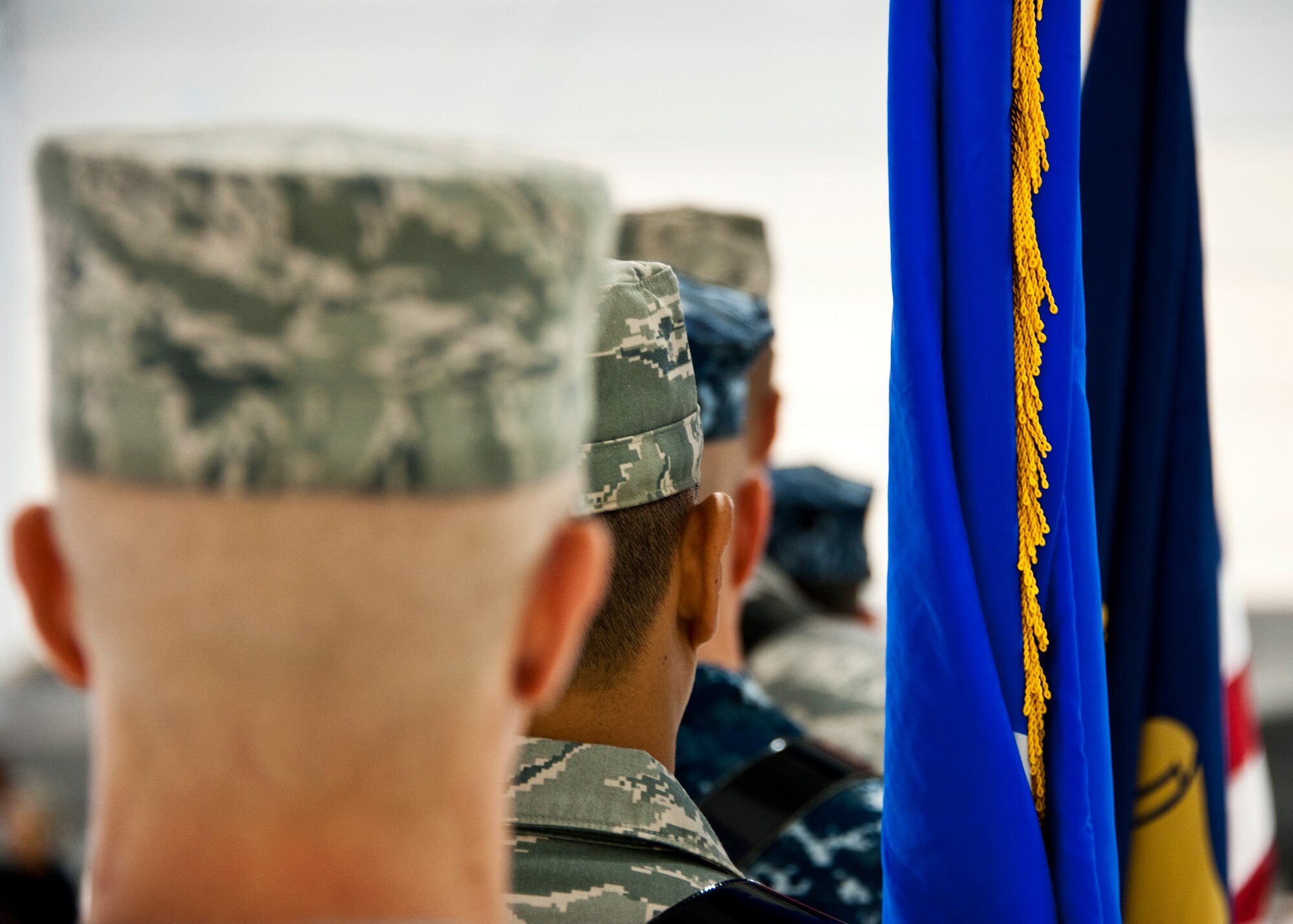 The newly-formed joint color guard team of 33rd Fighter Wing members waits to begin its first performance at a recent change of command ceremony at Eglin Air Force Base, Fla., Nov. 2. The joint color guard team members are:  Corpsman Sarah Lambert, Petty Officer 2nd Class James Peters, Senior Airman Chad Walker, Petty Officer 1st Class Jack Bauer, Master Sgt. Alexander Fortunato and Airman 1st Class Justin Glover.  (U.S. Air Force photo/Samuel King Jr.)
