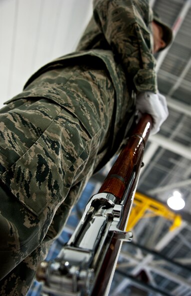 Airman 1st Class, Justin Glover, a low observable journeyman with the 33rd Maintenance Squadron, holds his rifle prior to his first performance with a joint color guard at Eglin Air Force Base, Fla., Nov. 2. Airmen and Sailors trained for a month to provide a joint-service color guard for a recent 33rd Fighter Wing squadron change of command.  (U.S. Air Force photo/Samuel King Jr.)