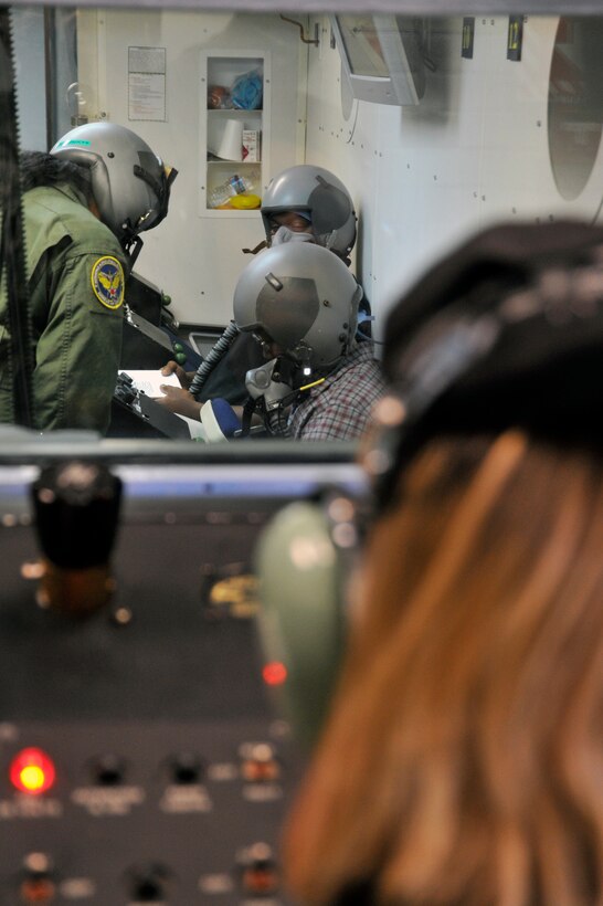 Senior Airman Shanna Thomas, 779th Aerospace Medicine Squadron inside observer, helps a student who has passed the “time of useful consciousness” make the proper corrections to stop hypoxia Nov. 2. The “time of useful consciousness” is the period of time from the interruption of the oxygen supply, or exposure to an oxygen-poor environment, to the time when useful function is lost and the individual is no longer capable of taking proper corrective and protective action to prevent hypoxia. If a student cannot perform the corrective action, the student fails the hypobaric chamber test. (U.S. Air Force photo/Senior Airman Perry Aston)
