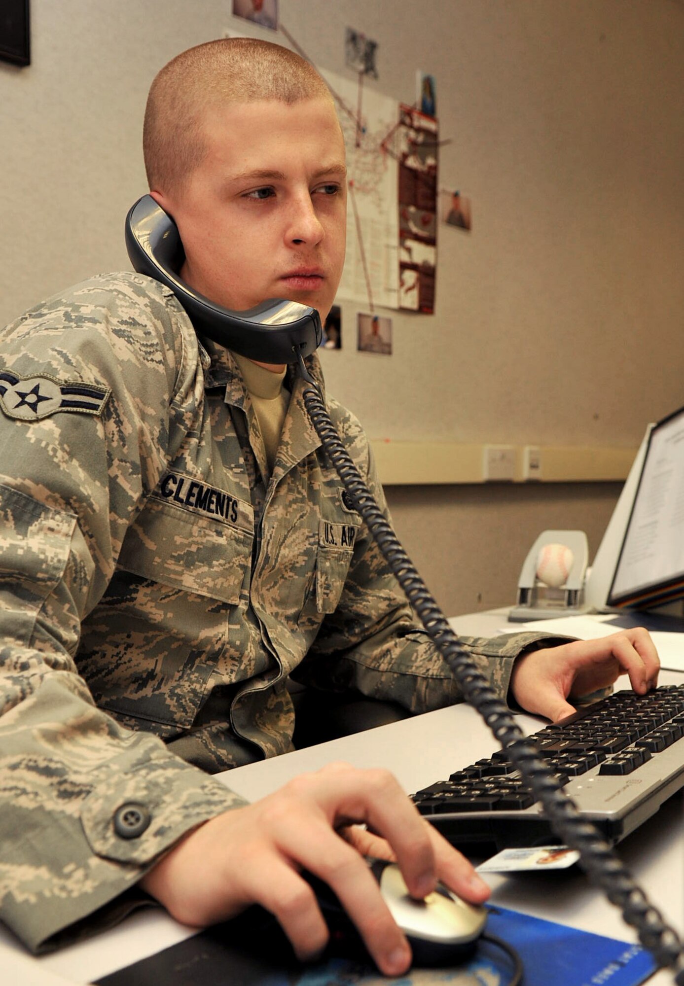 RAF MILDENHALL, England – Airman 1st Class Carl Clements, 100th Force Support Squadron, assists a customer over the phone at the military personnel section here Nov. 3, 2011. The force management section handles personnel duty information, including the updating of Air Force specialty codes and units of assignment, the processing of enlisted and officer performance reports, and various personnel functions for all of Team Mildenhall. (U.S. Air Force photo/Senior Airman Jerilyn Quintanilla)