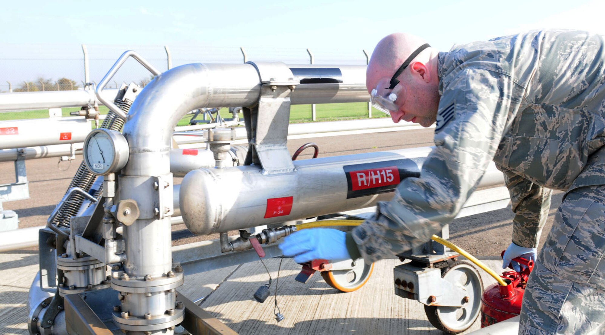 RAF MILDENHALL, England -- Staff Sgt. Chris Schultz, 100th Logistics Readiness Squadron Fuels Management Flight fuels expediter, drains an expansion tank after completing a refueling operations on a KC-135 Stratotanker. It’s vital to drain the tanks after every operation to avoid a build up of pressure, and to prevent overfilling the expansion tank. (U.S. Air Force photo/Karen Abeyasekere)