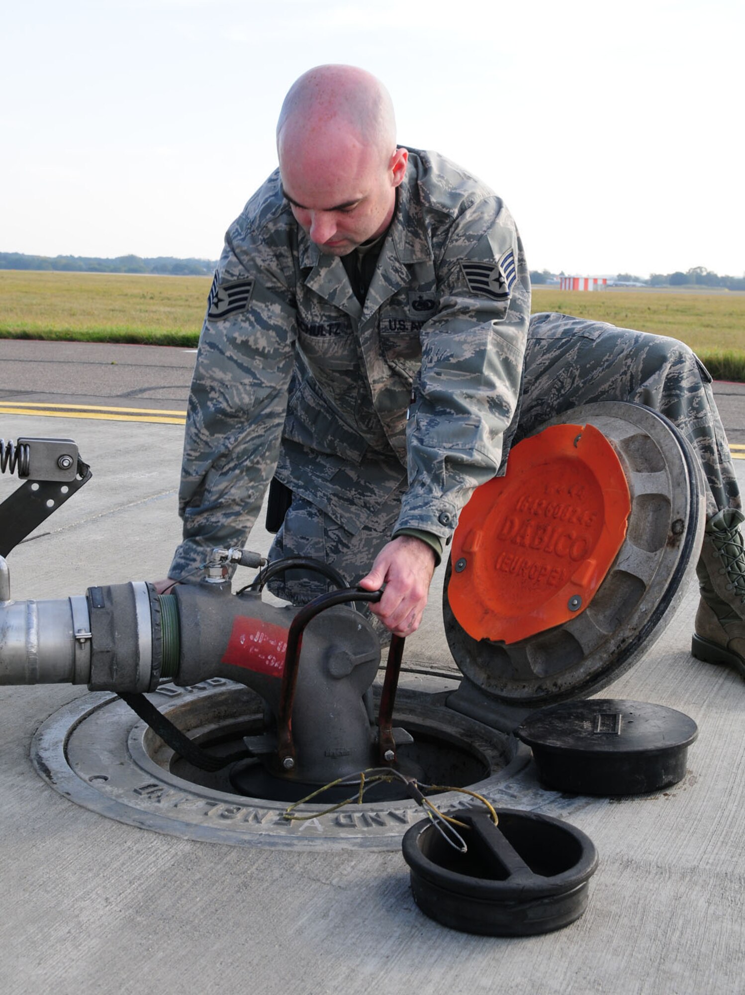 RAF MILDENHALL, England -- Staff Sgt. Chris Schultz, 100th Logistics Readiness Squadron Fuels Management Flight fuels expediter, connects a fuel transport system (pantograph) to refuel a transient aircraft here Oct. 24, 2011. The hydrant outlet is the connection point of the underground pipeline which feeds fuel from storage tanks to the hardstand. Received from a local supplier, fuel is piped to bulk storage containers around base, before being transferred to fuel trucks or piped to storage areas at hardstands. (U.S. Air Force photo/Karen Abeyasekere)