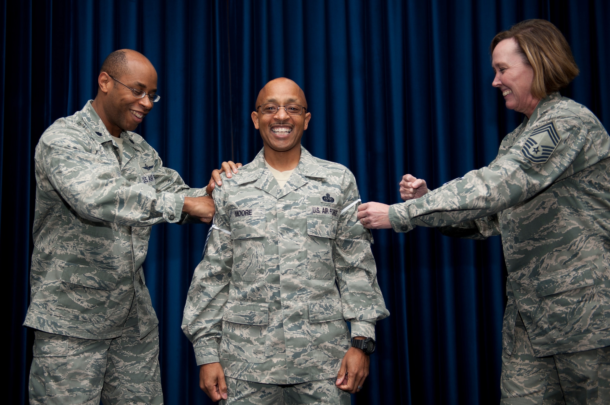 Senior Master Sgt. Jonathan Moore, center, 39th Communications Squadron, is congratulated by Lt. Col. Patrick Daniel, left, 39th Communications Squadron commander, and Chief Master Sgt. Rhonda Finch, 39th Communications Squadron, Oct. 3, 2011, at Incirlik Air Base, Turkey. Moore has been selected for promotion to chief master sergeant, the Air Force's highest enlisted rank. (U.S. Air Force photo by Tech. Sgt. Michael B. Keller/Released)