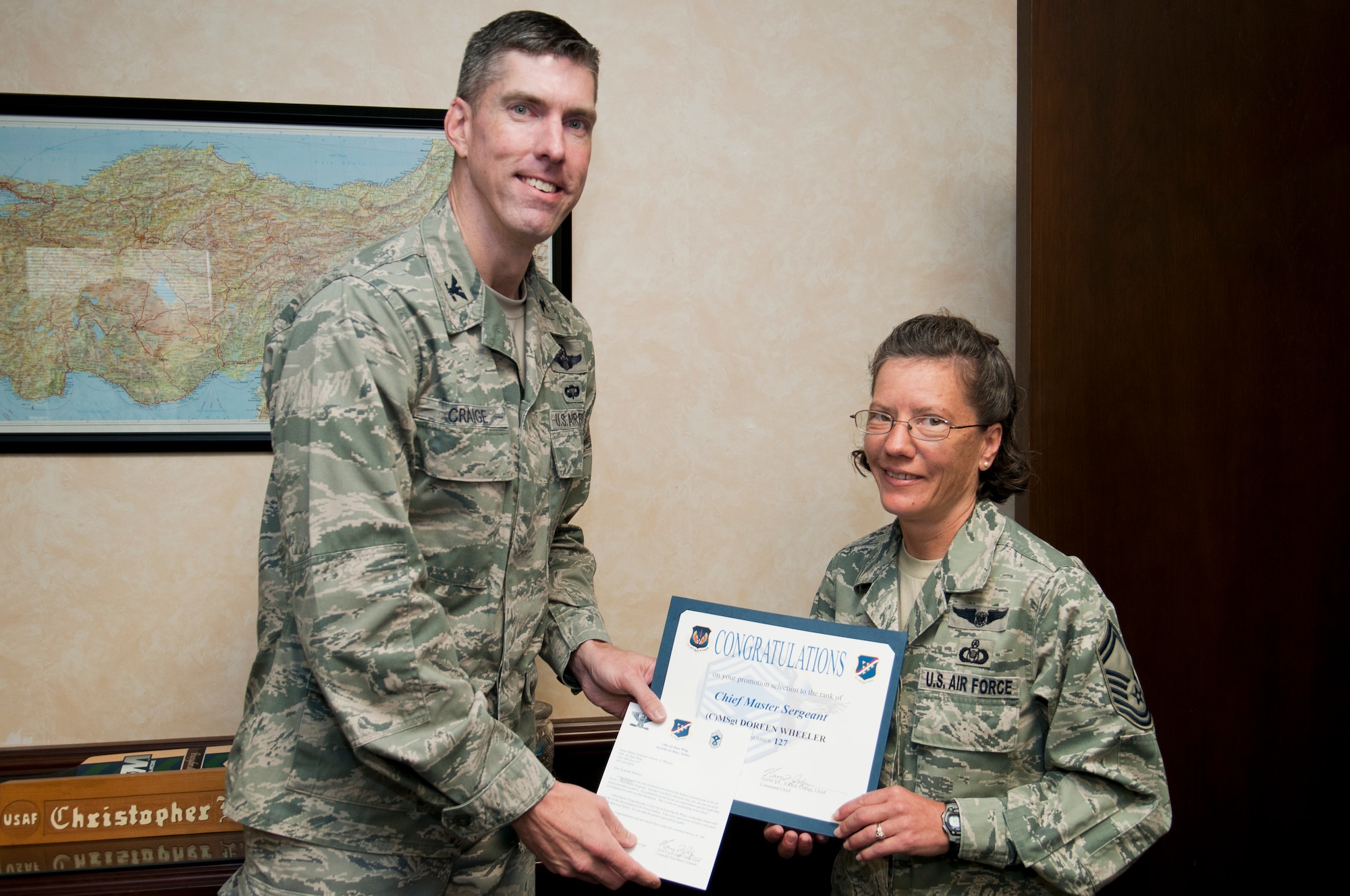 Senior Master Sgt. Doreen Wheeler, right, 39th Air Base Wing, receives a congratulatory certificate from Col. Chris Craige, 39th Air Base Wing commander, Oct. 3, 2011, at Incirlik Air Base, Turkey. Wheeler has been selected for promotion to chief master sergeant, the Air Force's highest enlisted rank. (U.S. Air Force photo by Tech. Sgt. Michael B. Keller/Released)
