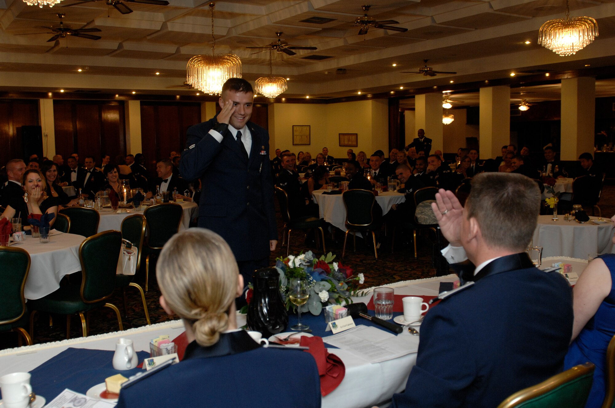ROYAL AIR FORCE LAKENHEATH, England--Airman 1st Class Collins Mensing, 48th Security Forces Squadron security patrolman, reports in to the dining-out president, Lt. Col. Paul Cairey, 48th SFS commander, Oct. 28, 2011. RAFs Lakenheath, Mildenhall, Alconbury, Honington and Croughton joined together for an all-U.K. Security Forces dining-out to honor all who wear the badge.   (U.S. Air Force photo by Tech. Sgt. Lee A. Osberry Jr.)