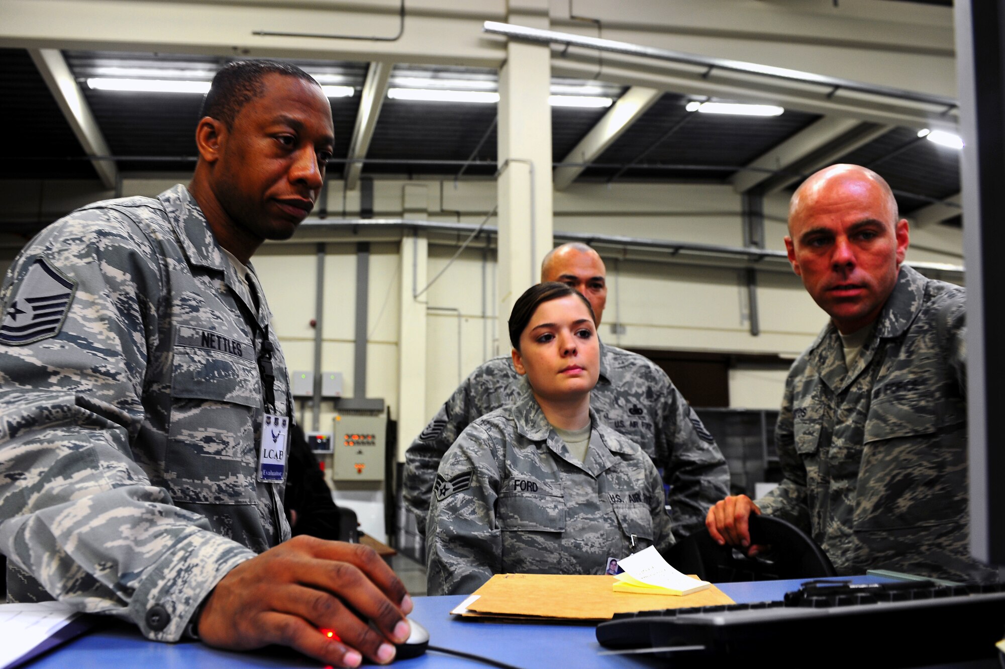 Air Force Logistics Compliance Assessment Program inspectors and 86th Logistics Readiness Squadron servicemembers review Individual Protective Equipment distribution policies during a LCAP inspection, Ramstein Air Base, Germany, Nov. 2, 2011. The biannual inspections determine overall readiness and safety compliance within logistic and maintenance squadrons (U.S. Air Force photo by Airman 1st Class Brea Miller)