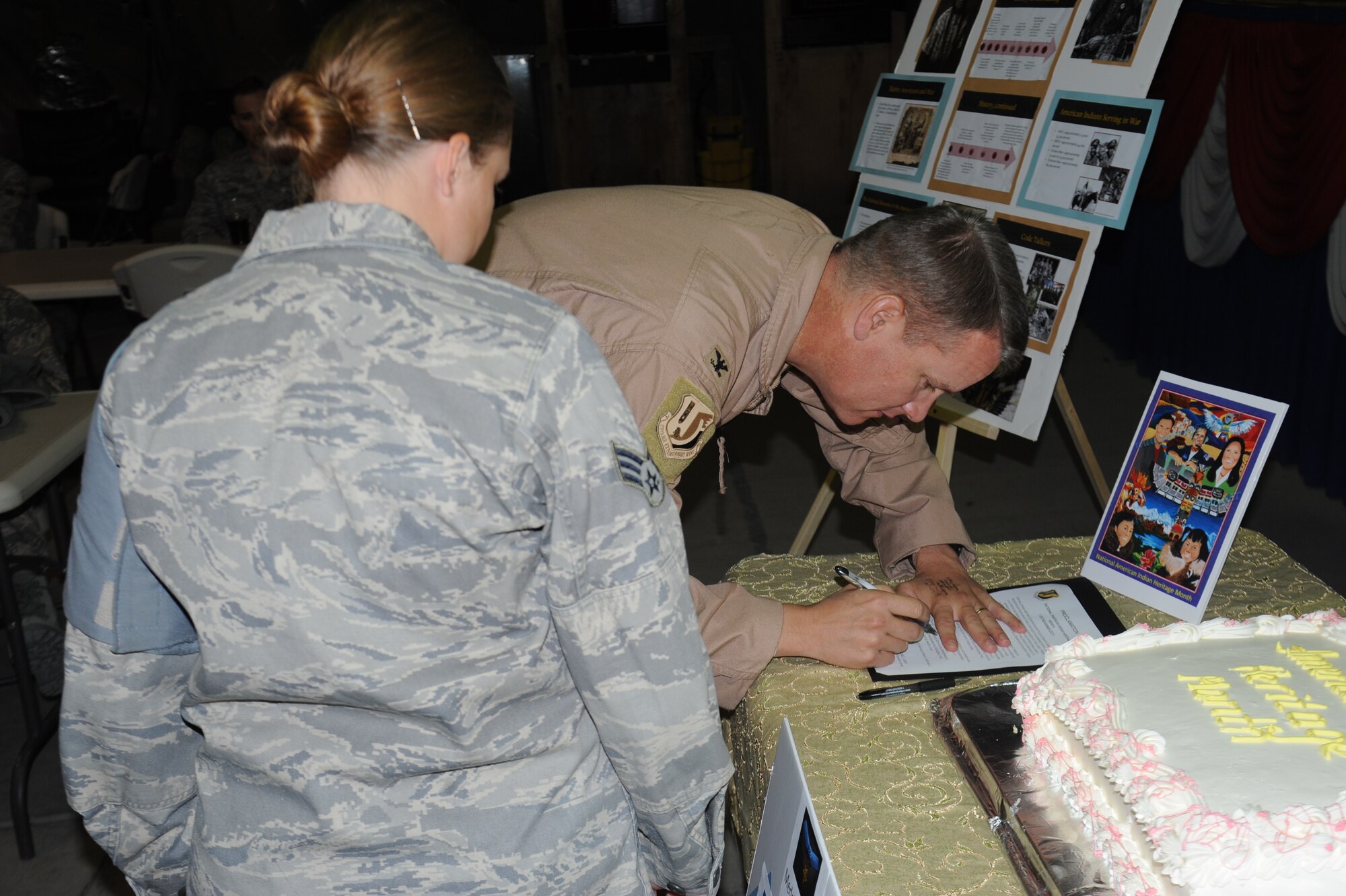 Senior Airman Rebecca Hall watches as Col. James Jacobson signs a proclamation in recognition of November being Native American History Month at the Transit Center at Manas, Kyrgyzstan, Nov. 3. Native Americans have served as valuable members of the armed forces for many years. Since World War II, 12 Native Americans have been awarded the Medal of Honor. Hall is a security controller assigned to the 376th Expeditionary Security Forces Squadron and is deployed from the 22nd Security Forces Squadron at McConnell Air Force Base, Kan. Jacobson is the commander of the 376th Air Expeditionary Wing. (U.S. Air Force photo/Tech. Sgt. Hank Hoegen)