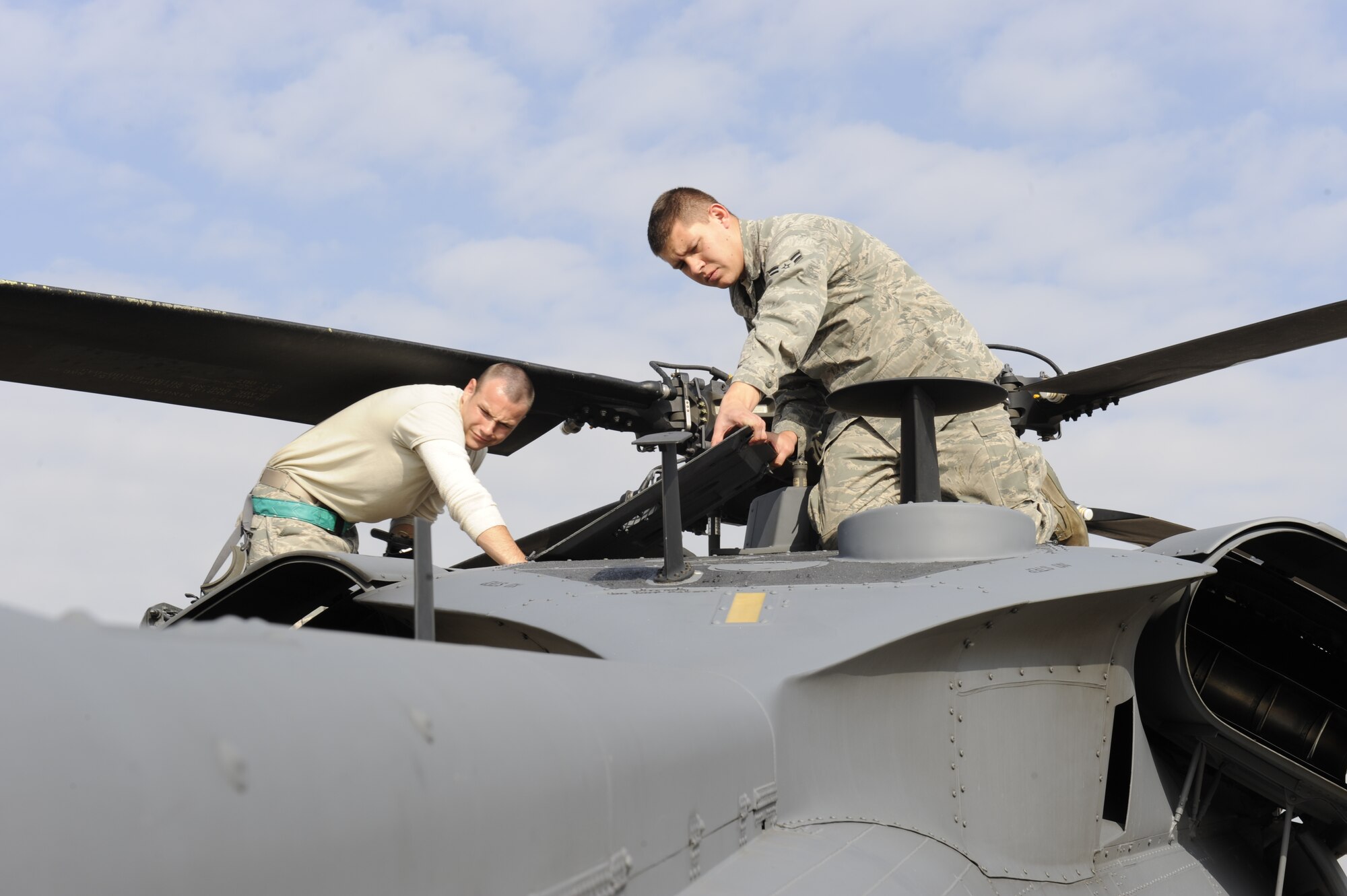 U.S. Air Force  Airman 1st Class Matt Morris and Senior Airman Dustin Unger, 33rd Helicopter Maintenance Unit  HH-60 Crew Chiefs, from Kadena Air Base, Japan, perform their post-flight checks on a Pave Hawk helicopter before a flight during exercise PACIFIC THUNDER Nov. 1, 2011 near Osan Air Base, Republic of Korea. 
Pacific Thunder is a 10-day exercise, from Oct. 31 to Nov. 9 at Osan AB. The exercise involves the 33rd Rescue Squadron from Kadena AB, Japan, and the 25th Fighter Squadron from Osan. These units work together to practice combat search and rescue tactics to prepare for real-world emergency situations. (U.S. Air Force photo/Tech. Sgt. Angelique Bilog/released)