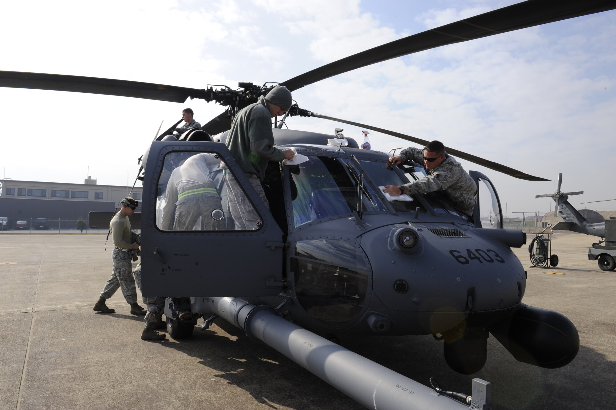 33rd Helicopter Maintenance Unit  HH-60 crew chiefs, from Kadena Air Base, Japan, perform their post-flight checks on a Pave Hawk helicopter before a flight during exercise PACIFIC THUNDER Nov. 1, 2011 near Osan Air Base, Republic of Korea.

Pacific Thunder is a 10-day exercise, from Oct. 31 to Nov. 9 at Osan AB. The exercise involves the 33rd Rescue Squadron from Kadena AB, Japan, and the 25th Fighter Squadron from Osan. These units work together to practice combat search and rescue tactics to prepare for real-world emergency situations. (U.S. Air Force photo/Tech. Sgt. Angelique Bilog/released)