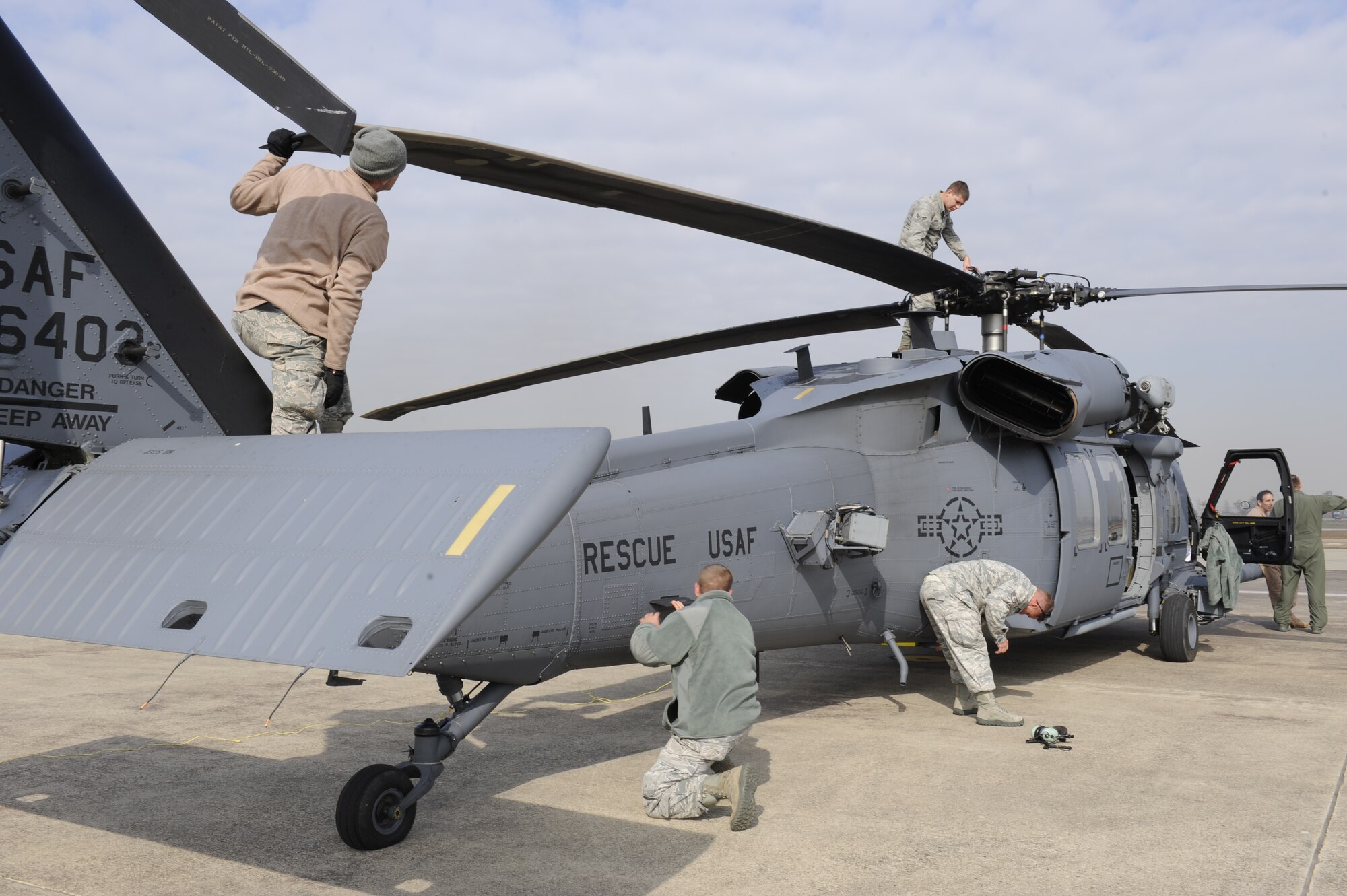 33rd Helicopter Maintenance Unit HH-60 crew chiefs, from Kadena Air Base, Japan, perform their post-flight checks on a Pave Hawk helicopter before a flight during exercise PACIFIC THUNDER Nov. 1, 2011 near Osan Air Base, Republic of Korea. 
Pacific Thunder is a 10-day exercise, from Oct. 31 to Nov. 9 at Osan AB. The exercise involves the 33rd Rescue Squadron from Kadena AB, Japan, and the 25th Fighter Squadron from Osan. These units work together to practice combat search and rescue tactics to prepare for real-world emergency situations. (U.S. Air Force photo/Tech. Sgt. Angelique Bilog/released)