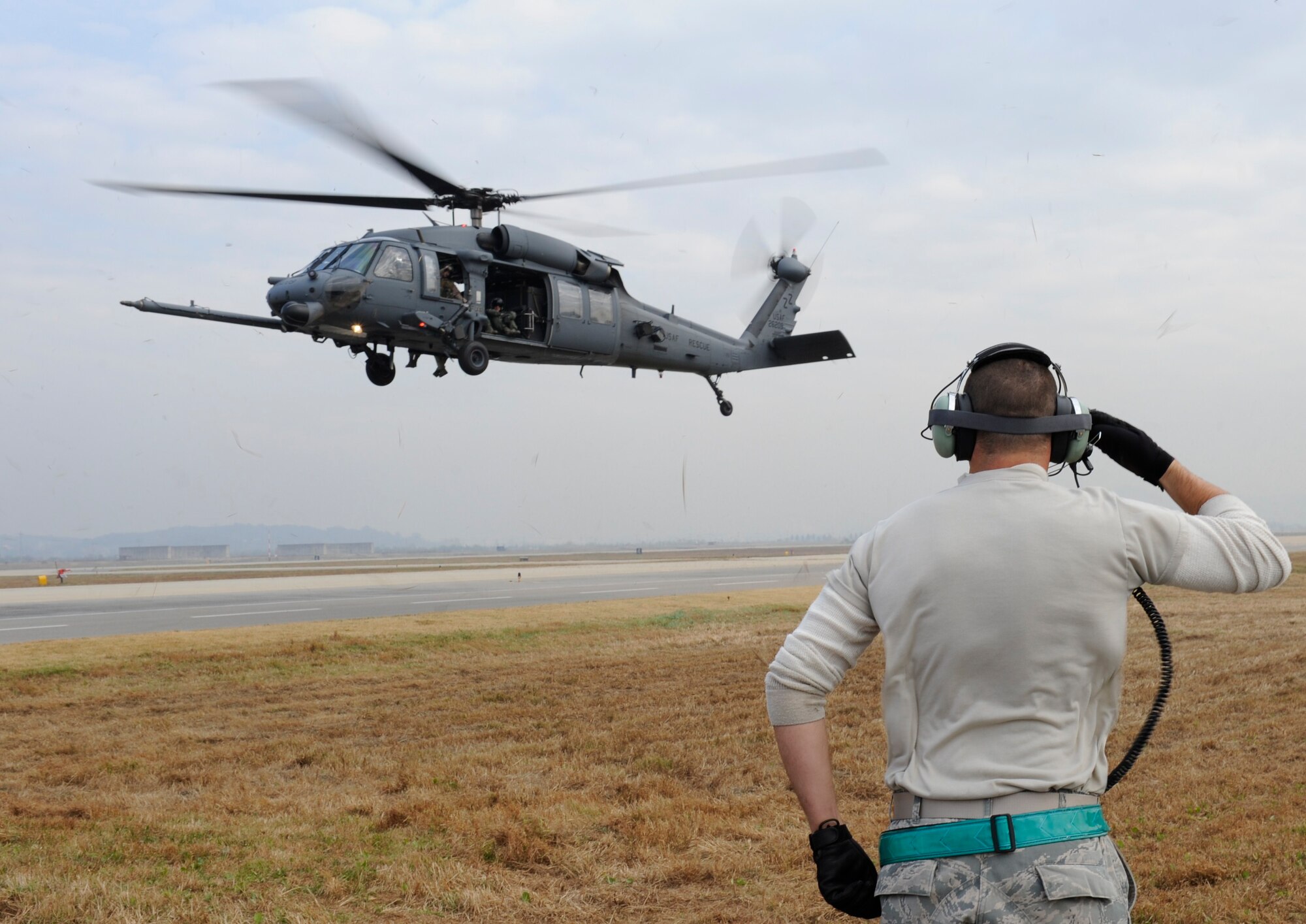 U.S. Air Force Senior Airman. Dustin Unger, 33rd Helicopter Maintenance Unit  HH-60 crew chief, from Kadena Air Base, Japan, salutes the Pave Hawk helicopter pilot as it takes off during exercise PACIFIC THUNDER Nov. 1, 2011 near Osan Air Base, Republic of Korea.

Pacific Thunder is a 10-day exercise, from Oct. 31 to Nov. 9 at Osan AB. The exercise involves the 33rd Rescue Squadron from Kadena AB, Japan, and the 25th Fighter Squadron from Osan. These units work together to practice combat search and rescue tactics to prepare for real-world emergency situations. (U.S. Air Force photo/Tech. Sgt. Angelique Bilog/released)