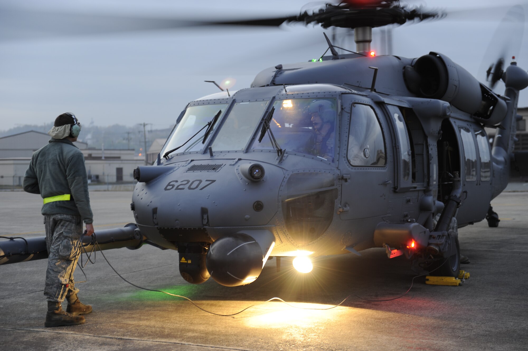 U.S. Air Force Airman 1st Class Matt Morris, a 33rd Helicopter Maintenance Unit HH-60 crew chief from Kadena Air Base, Japan, prepares a Pave Hawk helicopter for take-off during exercise Pacific Thunder Nov. 1, 2011, near Osan Air Base, Republic of Korea. Pacific Thunder is a 10-day exercise, from Oct. 31 to Nov. 9 at Osan AB. The exercise involves the 33rd Rescue Squadron from Kadena AB, Japan, and the 25th Fighter Squadron from Osan. These units work together to practice combat search and rescue tactics to prepare for real-world emergency situations. (U.S. Air Force photo/Tech. Sgt. Angelique Bilog/released)
