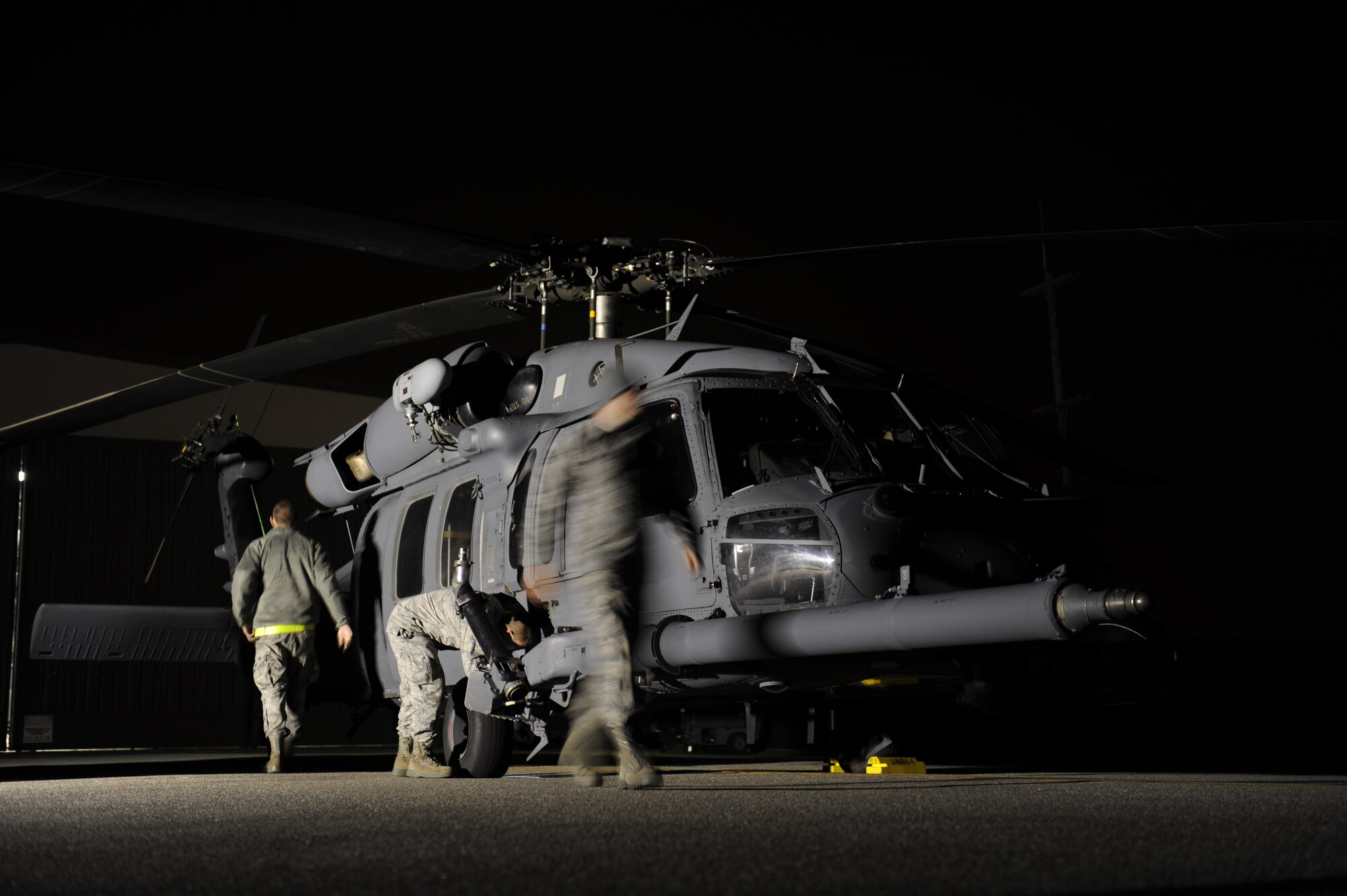 33rd Helicopter Maintenance Unit HH-60 crew chiefs, from Kadena Air Base, Japan, perform pre-flight checks on a Pave Hawk helicopter before a flight during exercise Pacific Thunder Nov. 1, 2011 near Osan Air Base, Republic of Korea. Pacific Thunder is a 10-day exercise, from Oct. 31 to Nov. 9 at Osan AB. The exercise involves the 33rd Rescue Squadron from Kadena AB, Japan, and the 25th Fighter Squadron from Osan. These units work together to practice combat search and rescue tactics to prepare for real-world emergency situations. (U.S. Air Force photo/Tech. Sgt. Angelique Bilog/released)

