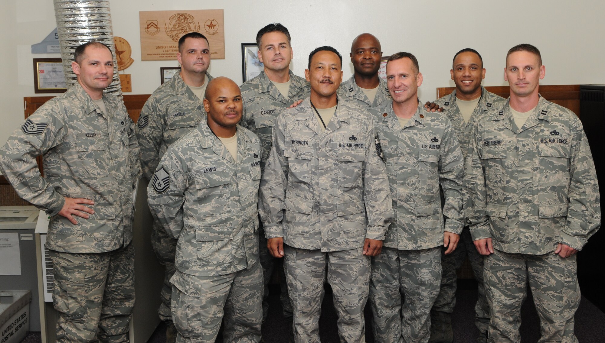 KADENA AIR BASE, Japan -- Senior Master Sgt. Mack Wysinger III (center front) and other members the 353rd Special Operations Maintenance Squadron pose for a photo after Sergeant Wysinger was informed of his selection for promotion to chief master sergeant here Nov. 3.