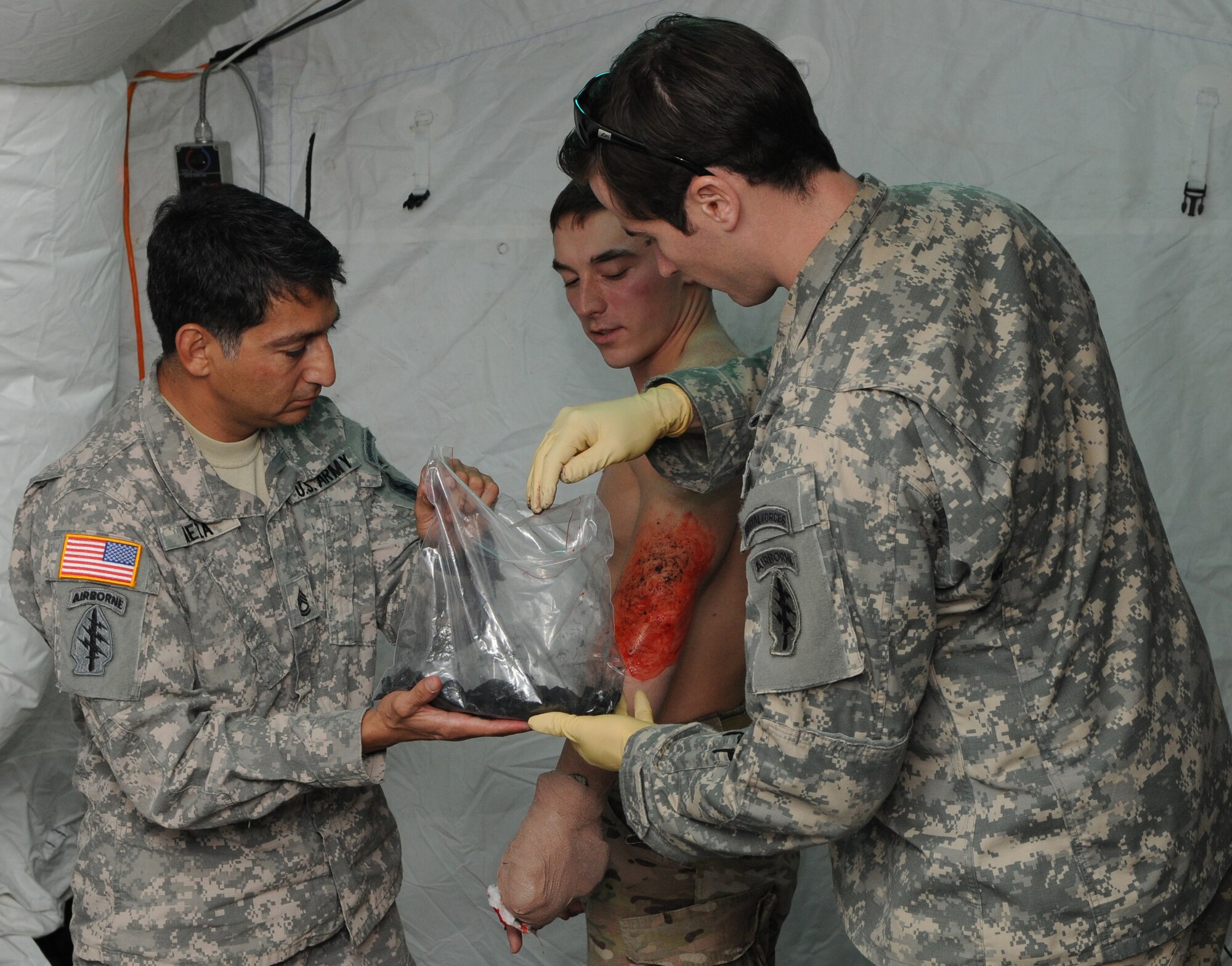 KADENA AIR BASE, Japan -- Sgt. 1st Class Gregory Meza and Staff Sgt. Matthew Lalor, both special operations medics from the 1st Battalion, 1st Special Forces Group (Airborne), add charcoal to a simulated burn to make it more realistic during a class here Oct. 27. Medics from the 353rd Special Operations Support Squadron noted the finished product look just like burns they had seen while treating patients in the past. (U.S. Air Force photo by Tech. Sgt. Aaron Cram)