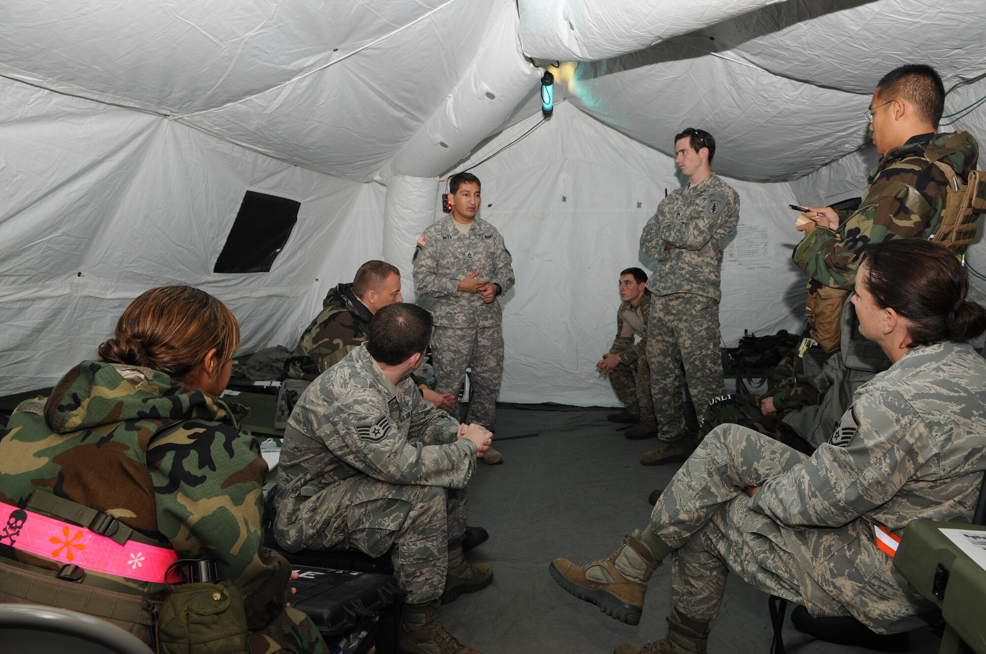 KADENA AIR BASE, Japan -- Sgt. 1st Class Gregory Meza, a special operations medic from the 1st Battalion, 1st Special Forces Group (Airborne), discusses techniques he used to improve training while an instructor to other SOF medics here Oct 27. Two SOF medics helped teach medics from the 353rd Special Operations Support Squadron ways to improve future medical training scenarios during a brief class. (U.S. Air Force photo by Tech. Sgt. Aaron Cram)