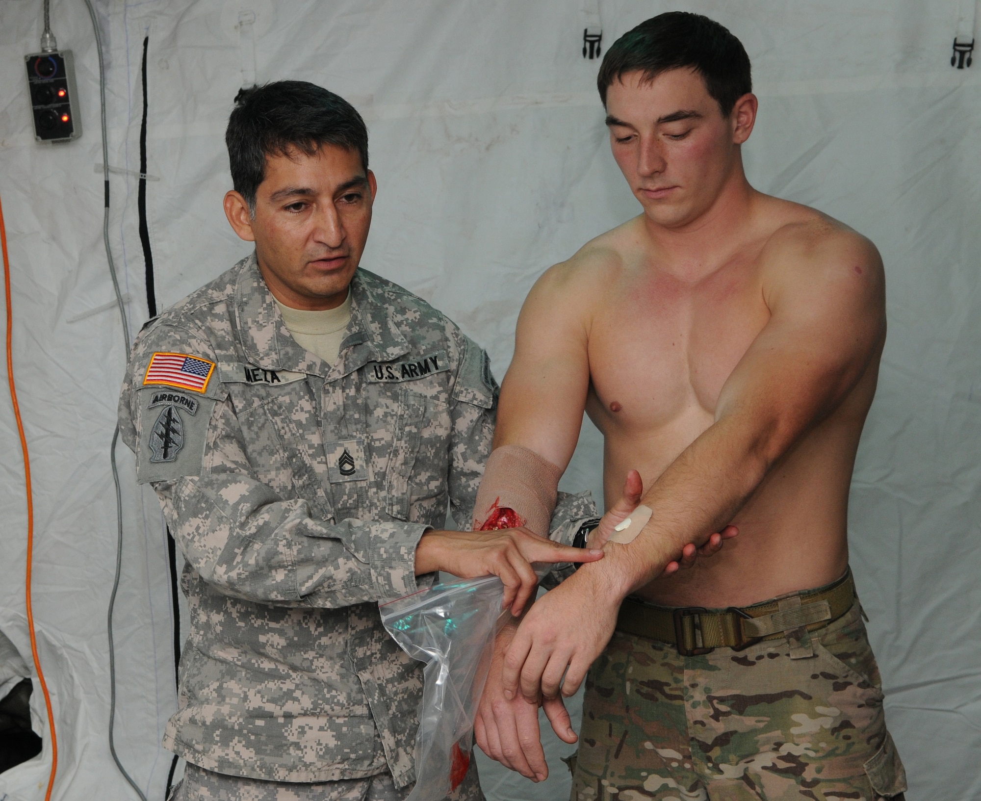 KADENA AIR BASE, Japan -- Sgt. 1st Class Gregory Meza, a special operations medic from the 1st Battalion, 1st Special Forces Group (Airborne), shows the initial step he uses to create a compound fracture using PVC pipe during a class here Oct. 27. Two SOF medics helped teach medics from the 353rd Special Operations Support Squadron ways to improve future medical training scenarios during a brief class. (U.S. Air Force photo by Tech. Sgt. Aaron Cram)