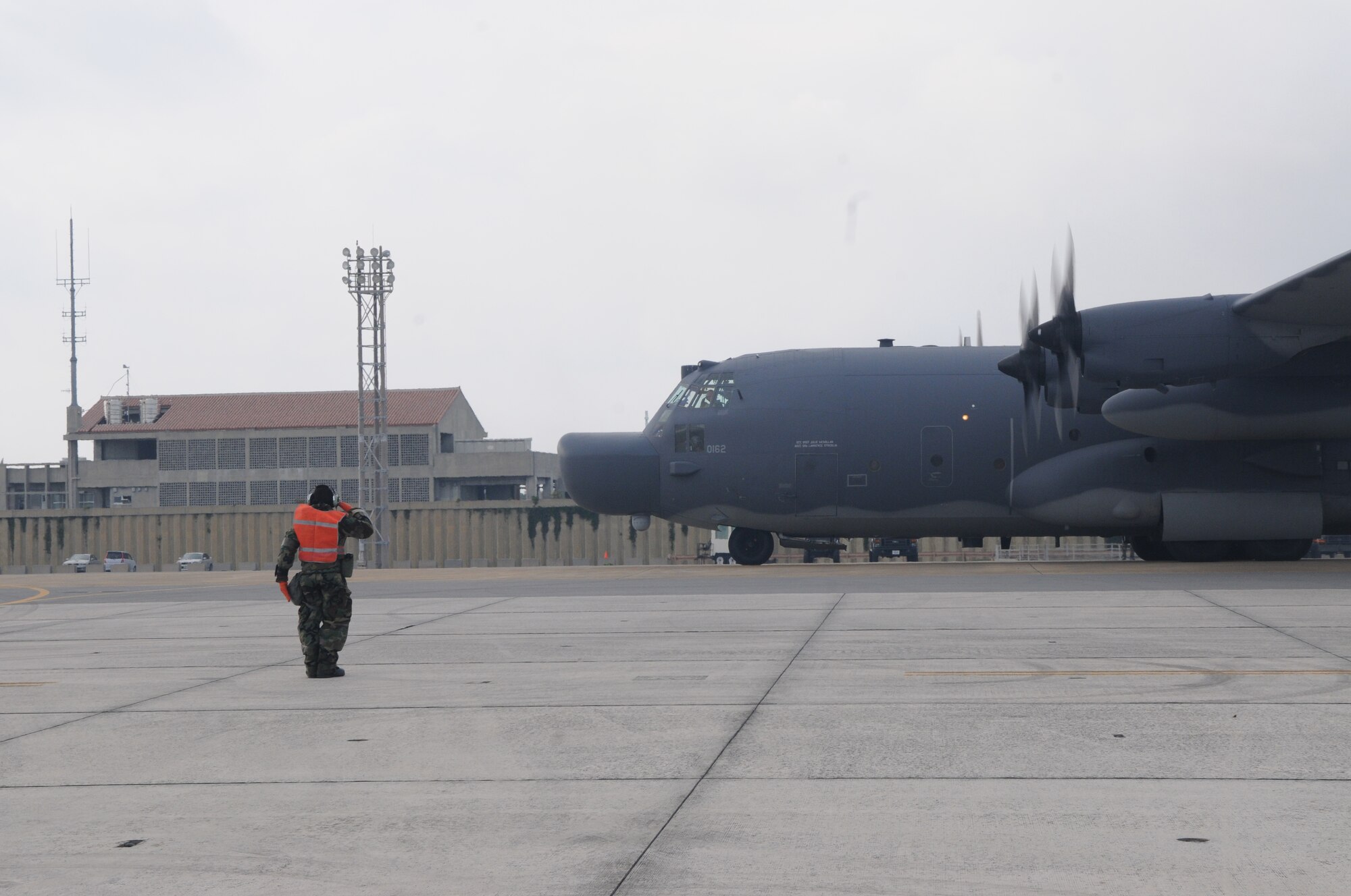 KADENA AIR BASE, Japan -- Airman 1st Class Jeremiah Dobson, 353rd Special Operations Maintenance Squadron, salutes the aircraft commander of a MC-130H Combat Talon II prior to takeoff during a local operational readiness exercise here Oct 26. Airmen from the 353rd Special Operations Group honed their wartime readiness during exercise Beverly High 12-1 Oct. 24-28 (U.S. Air Force photo by Tech. Sgt. Aaron Cram)