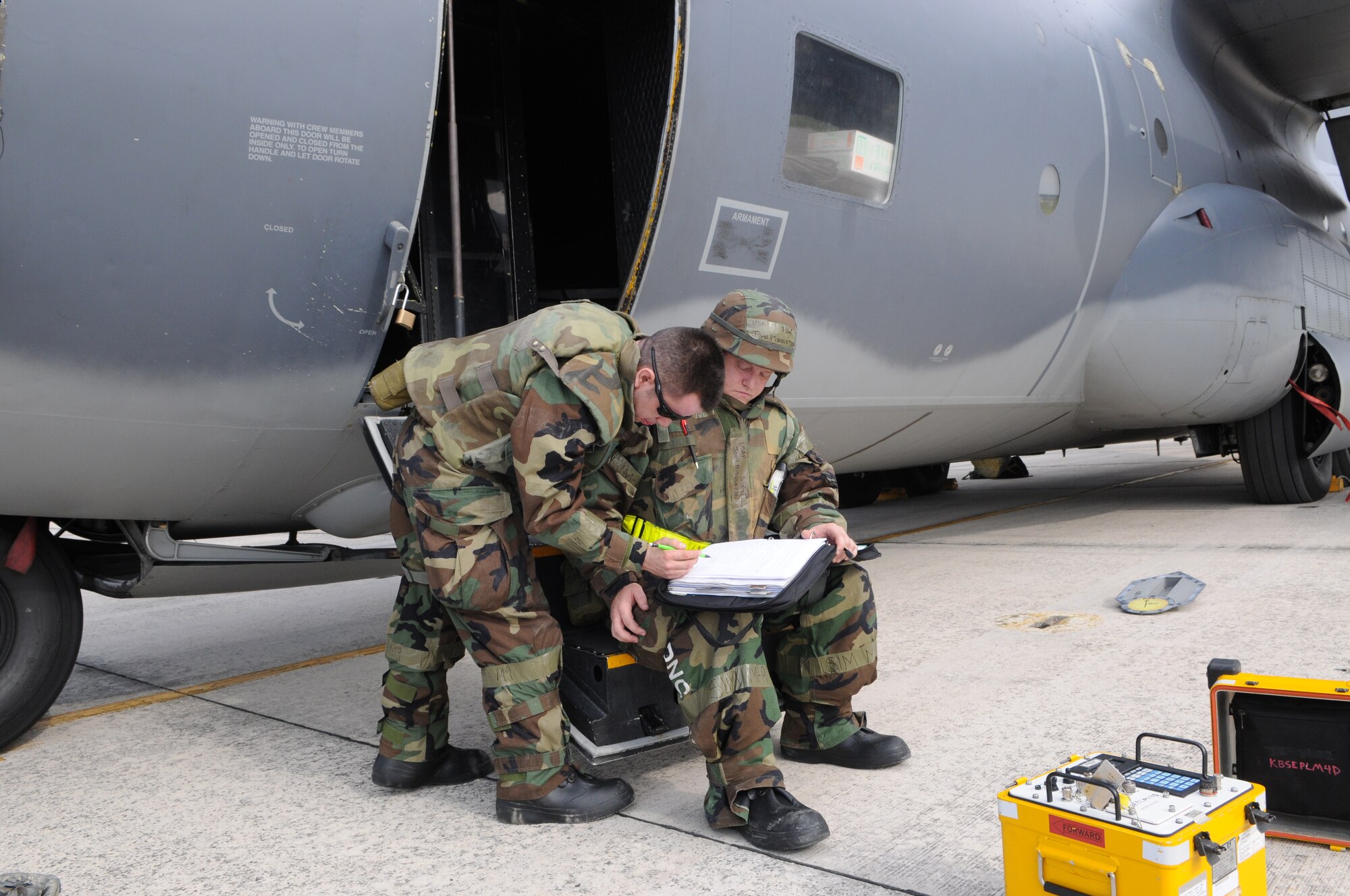 KADENA AIR BASE, Japan -- Staff Sgt. John Middleton (right)and Airman 1st Class Christian Hernandez, both from the 353rd Special Operations Maintenance Squadron, annotate maintenance on forms after replacing an antenna on a MC-130P Combat Shadow during a local operational readiness exercise here Oct 26. Airmen from the 353rd Special Operations Group honed their wartime readiness during exercise Beverly High 12-1 Oct. 24-28 (U.S. Air Force photo by Tech. Sgt. Aaron Cram) 
