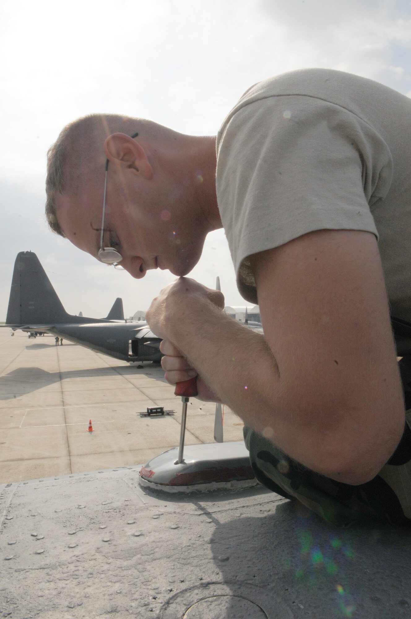KADENA AIR BASE, Japan -- Airman 1st Class Anthony Silveroli, 353rd Special Operations Maintenance Squadron, tightens a screw after replacing an antenna on a MC-130P Combat Shadow during a local operational readiness exercise here Oct 26. Airmen from the 353rd Special Operations Group honed their wartime readiness during exercise Beverly High 12-1 Oct. 24-28 (U.S. Air Force photo by Tech. Sgt. Aaron Cram)