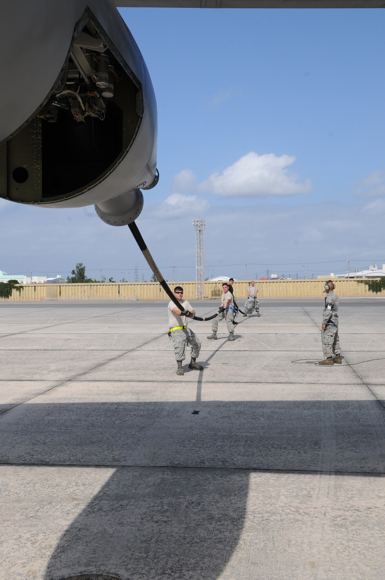 KADENA AIR BASE, Japan -- Maintainers from the 353rd Special Operations Maintenance Squadron guide the refueling hose into its pod after maintenance on a MC-130P Combat Shadow during a local operational readiness exercise here Oct 26. Airmen from the 353rd Special Operations Group honed their wartime readiness during exercise Beverly High 12-1 Oct. 24-28 (U.S. Air Force photo by Tech. Sgt. Aaron Cram)
