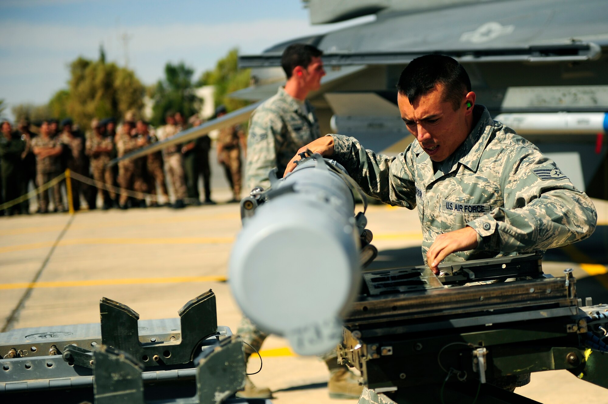 A U.S. Air Force weapons load team from the 388th Aircraft Maintenance Squadron at Hill Air Force Base, UT, participates in a loading competition in support of Falcon Air Meet, Oct. 18, 2011. FAM is a multi-national exercise and operational activity in Jordan that enhances regional partnerships and interoperability as well as demonstrates U.S. commitment to regional security and stability. (U.S. Air Force photo/Senior Airman Asha Kin)
