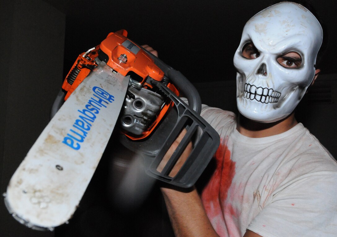 Airman 1st Class Jermey Renner, 36th Civil Engineer Squadron 'Dirt Boy'
and house volunteer, scares attendees as they are walking past.  The
haunted house is a yearly event put on by 36 CES volunteers and was open to all ages for enjoyment.  (U.S. Air Force photo/Airman 1st Class
Mariko Frazee)
