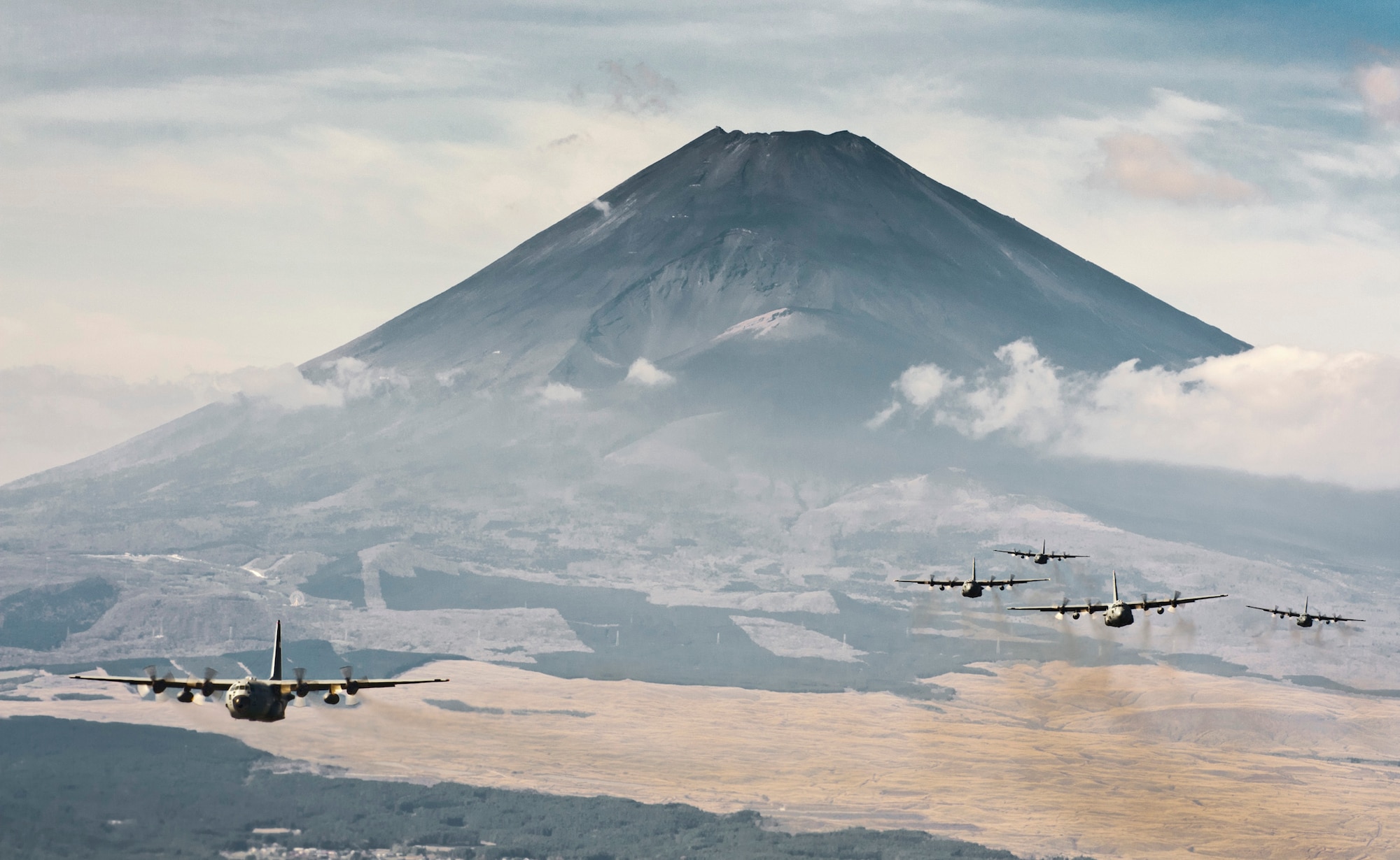 OVER JAPAN -- A formation of C-130 Hercules cargo aircraft fly in formation during a Samurai Surge training mission near Mount Fuji, Japan, Nov. 2, 2011. The 374th Airlift Wing uses C-130s to perform intra theater airlift missions in the western Pacific region. (U.S. Air Force photo/Staff Sgt. Samuel Morse)