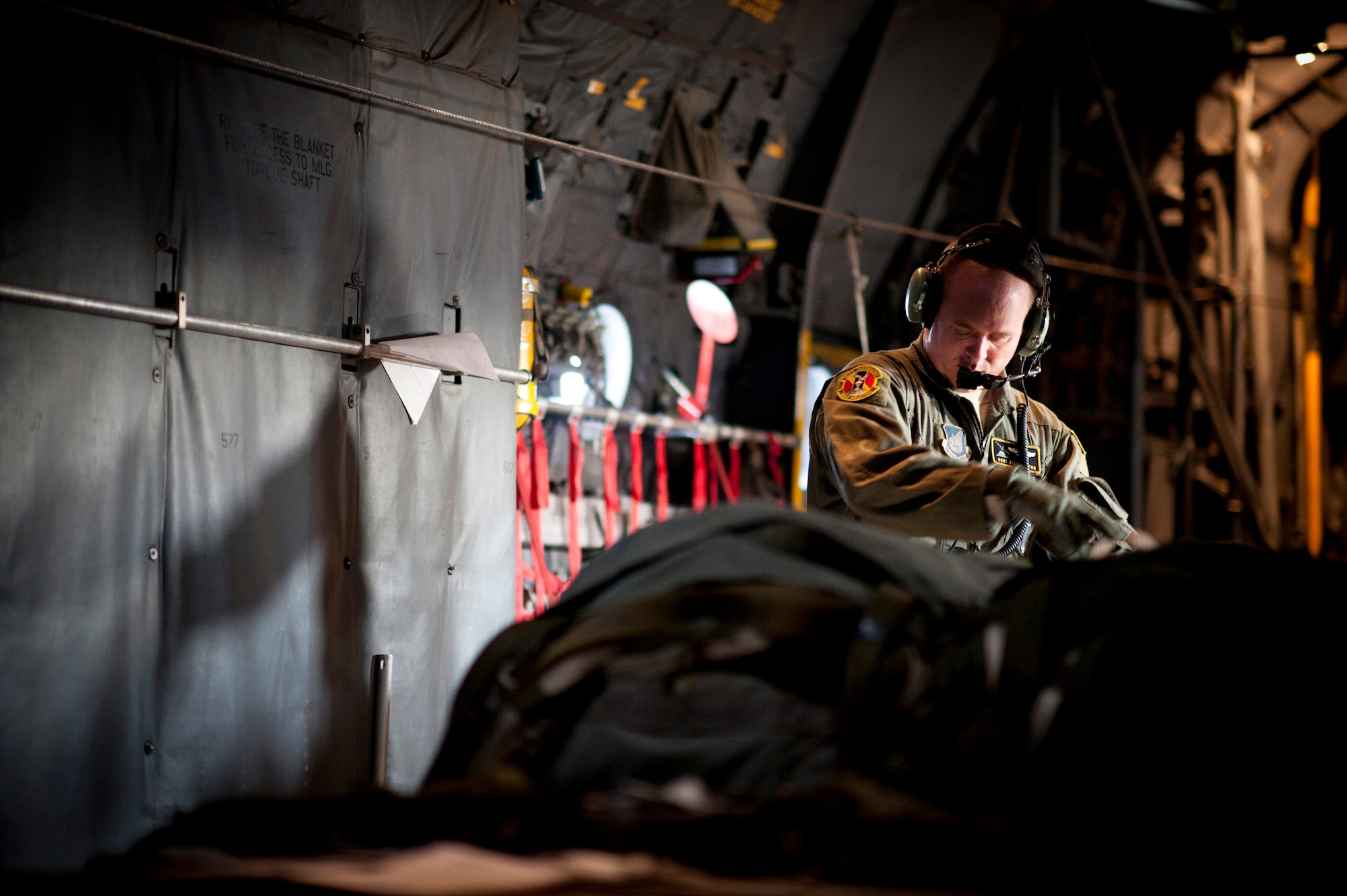 YOKOTA AIR BASE, Japan -- Staff Sgt. Jace Hartog, 36th Airlift Squadron loadmaster, checks training bundles on a C-130 Hercules in preparation for a Samurai Surge at Yokota Air Base, Japan, Nov. 2, 2011. The crew practiced dropping three different categories of equipment bundles over drop zones at Yokota Air Base and Mount Fuji. (U.S. Air Force photo/Staff Sgt. Samuel Morse)