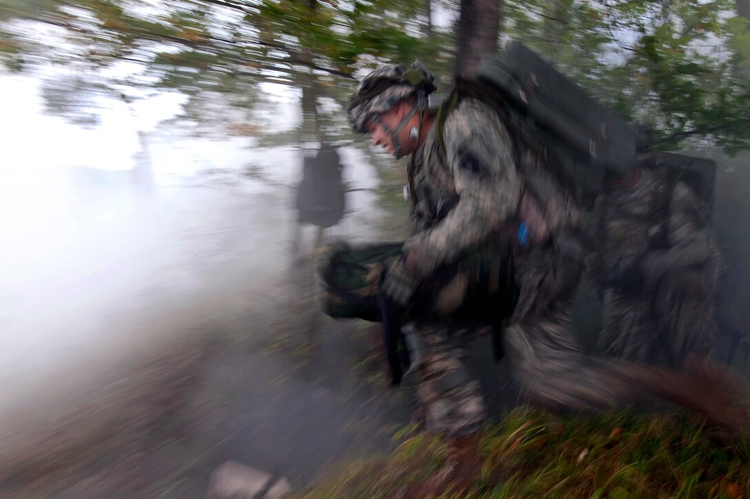 U.S. Army engineers run towards the concertina wire and mine field to drop their charges and clear the road for fellow soldiers during a situational training exercise as part of the Full Spectrum Training Event in Hohenfels, Germany, Oct. 10, 2011. The engineers are assigned to the 173rd Airborne Brigade Combat Team.