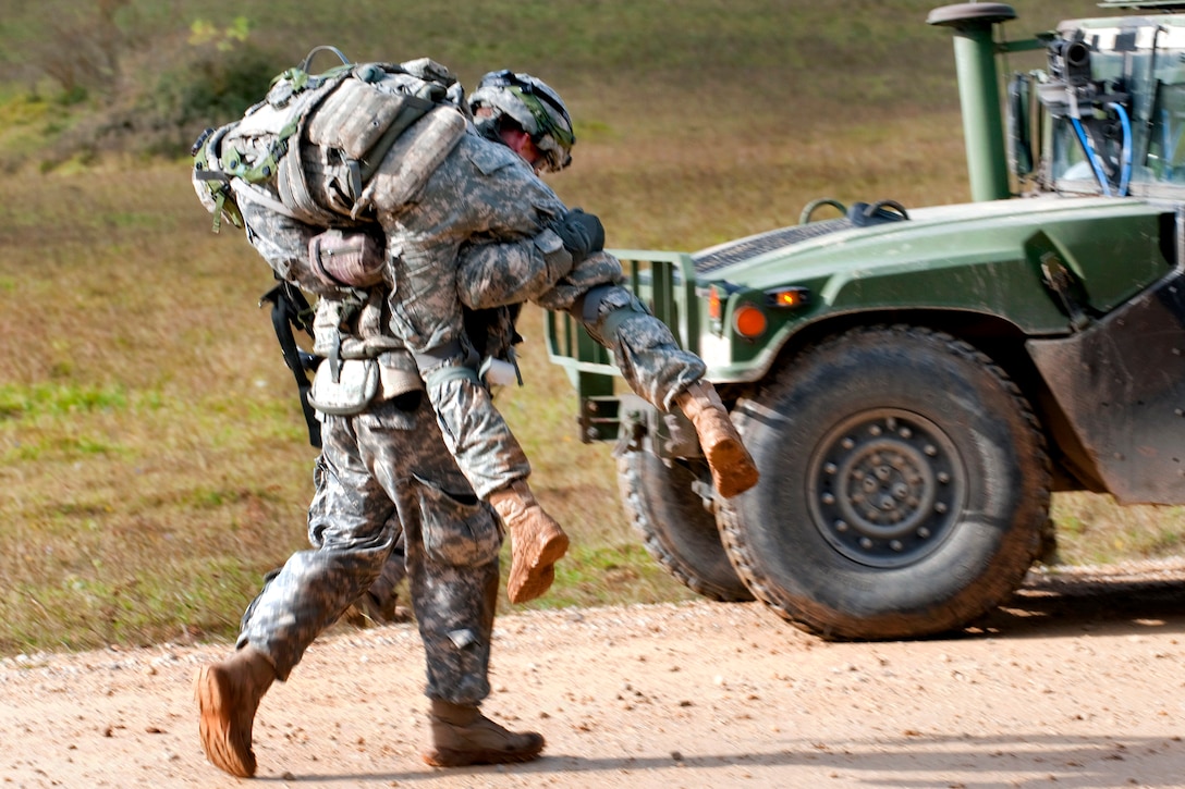 U.S. Army Spc. Robert Bundy carries an injured team member to safety during a situational training exercise as part of their Full Spectrum Training Event in Hohenfels, Germany, Oct. 11, 2011. Bundy is a medic assigned to Company H, 1st Battalion, 503rd Infantry, 173rd Airborne Brigade Combat Team.
