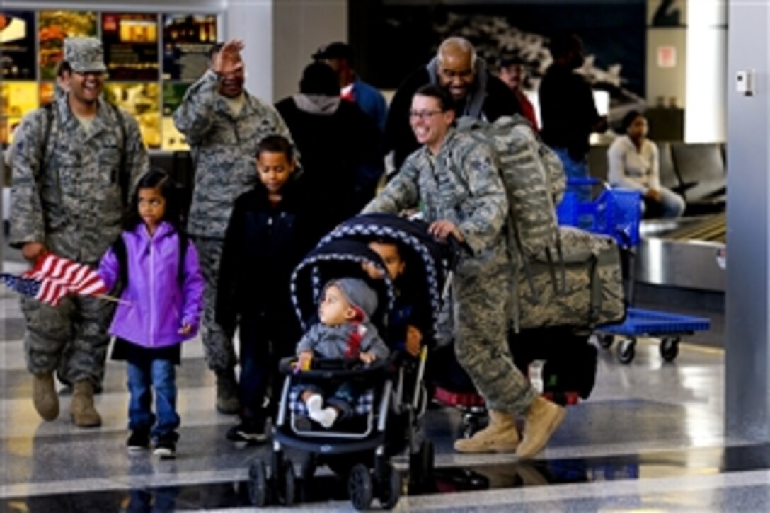 Senior Airmen Kristian Robles Cruz , right, greets family members and co-workers at the Newport News, Va., airport upon arriving home from Iraq, Nov. 2, 2011. Cruz is assigned to the 633rd Security Forces Squadron based at Joint Base Langley-Eustis, Va. 