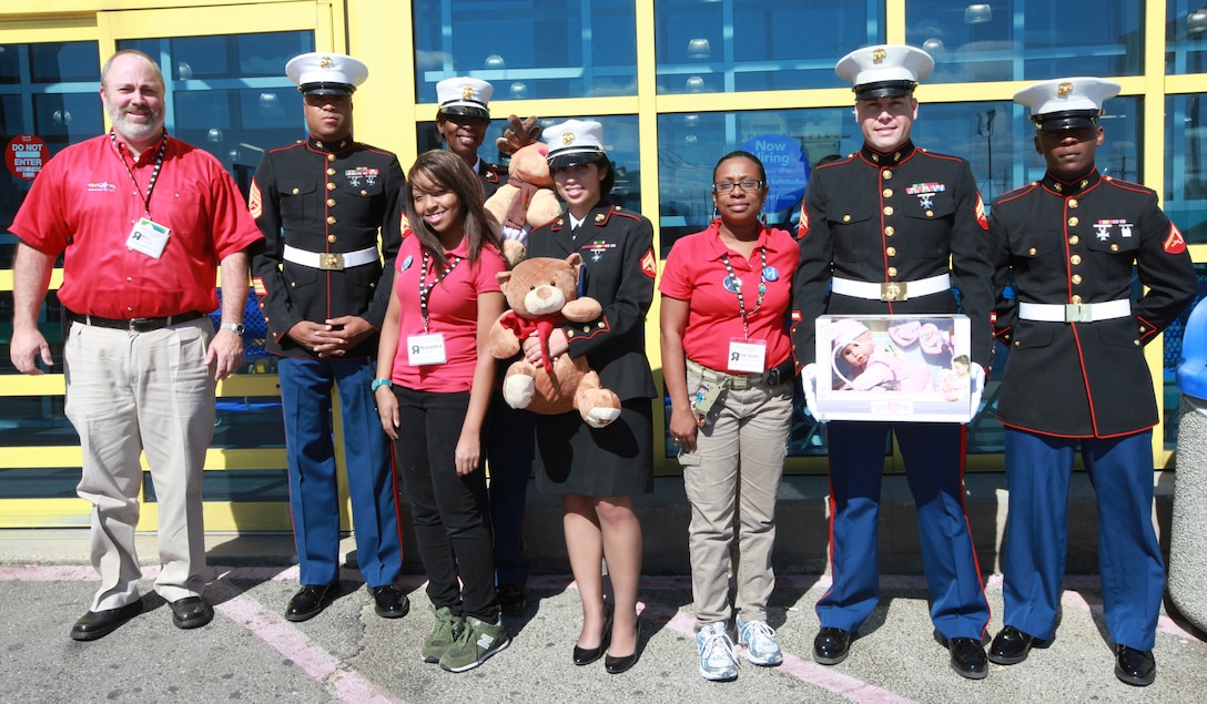 Marine Forces Reserve Marines and Toys R Us staff present toys they collected at the Metairie, La., location Nov. 4. From left to right- Bill McGee, Toys R Us Metairie store manager; Gunnery Sgt. Jimmy Cosby Jr., the pay deck staff noncommissioned officer for the MarForRes disbursing office; Natasha Riley, Toys R Us team member; Cpl. Crystal Dunaway, Travel Management Office clerk; Cpl. Cristel Zimmermanoset, zeros clerk at the finance office; GeJoan Garrett, Toys R Us department supervisor; Cpl. Herbert B. Bryant, maintenance management specialist; Lance Cpl. James A. Everett, maintenance management analyst.