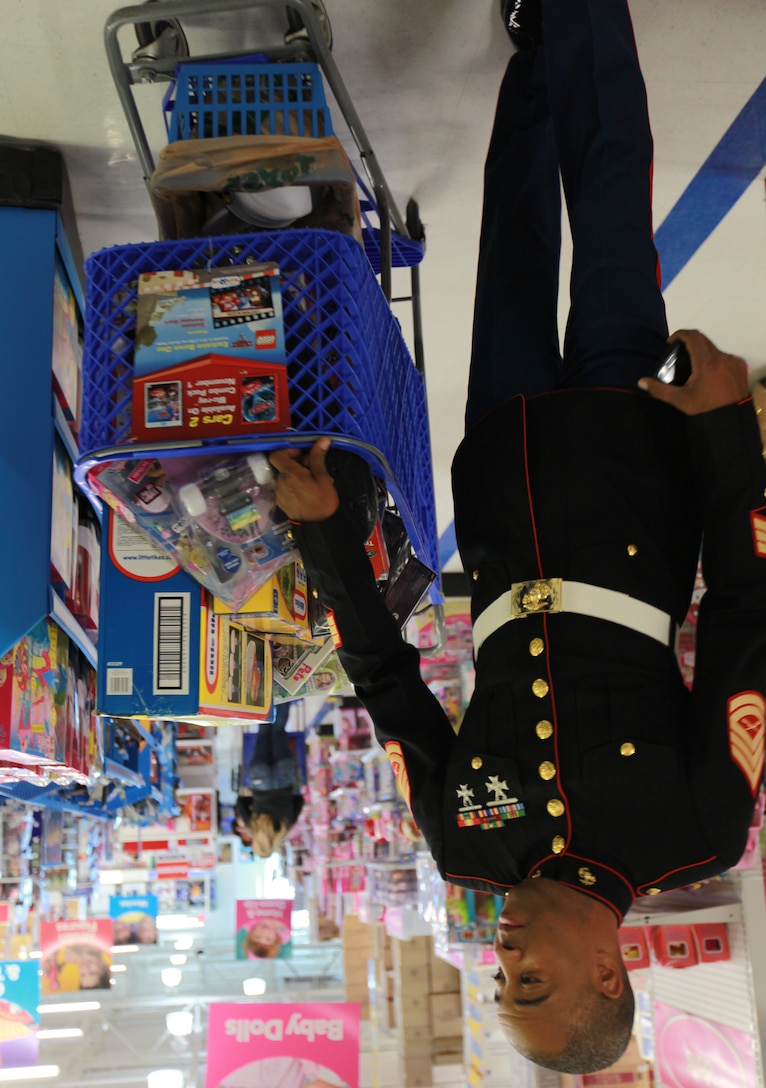 Gunnery Sgt. Jimmy Cosby Jr., the pay deck staff noncommissioned officer for the Marine Forces Reserve disbursing office, takes a stroll with a full cart of toys Nov. 4 at the Toys R Us in Metairie, La. The Metairie location sponsored the $1,400 shopping spree for MarForRes, in which Marines bought three carts of toys for the Toys for Tots program.