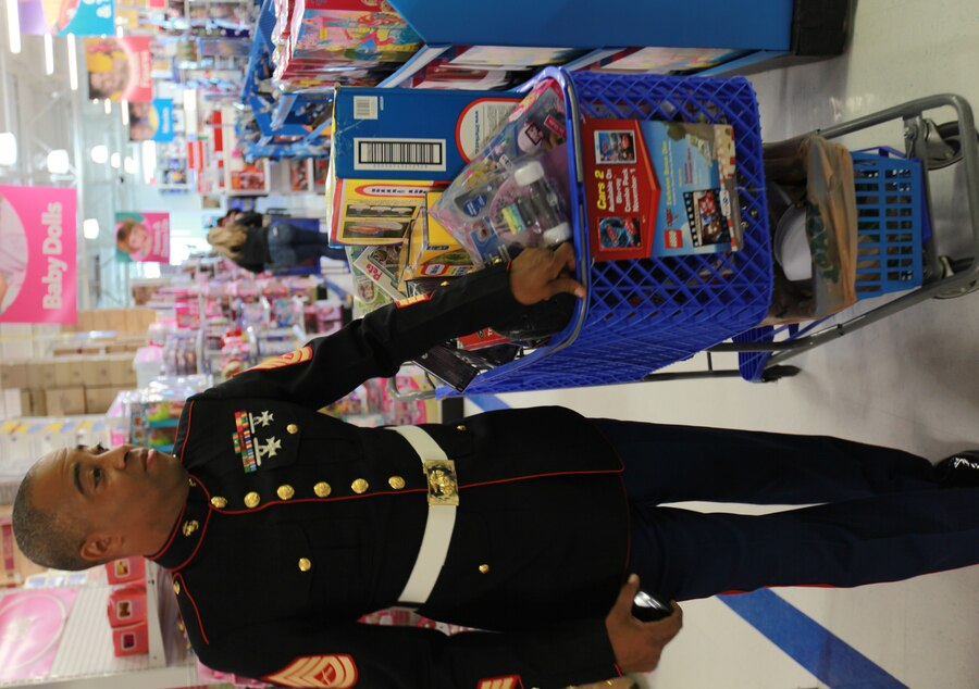 Gunnery Sgt. Jimmy Cosby Jr., the pay deck staff noncommissioned officer for the Marine Forces Reserve disbursing office, takes a stroll with a full cart of toys Nov. 4 at the Toys R Us in Metairie, La. The Metairie location sponsored the $1,400 shopping spree for MarForRes, in which Marines bought three carts of toys for the Toys for Tots program.
