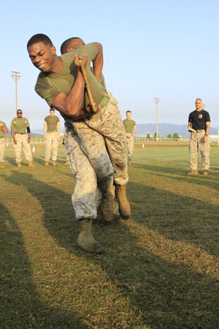 Lance Cpl. Byron D. Johnson, Headquarters department and station Installation Personnel Administration Center diary clerk, competes and wins the finals for Headquarters department in the Own the Bone competition during the Headquarters and Headquarters Squadron field meet at Penny Lake fields here, Nov. 4. The four Squadron departments competed to build unit cohesion.