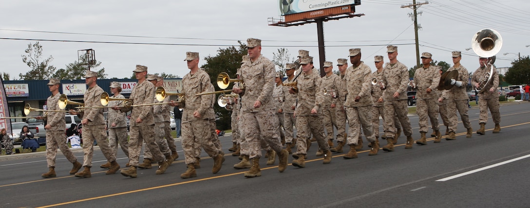 The 2nd Marine Division Band was the first to march and play music during the Veterans Day Parade in Jacksonville, Nov. 5. Families gathered along the roadside to cheer and watch the floats, which stretched from Coastal Carolina Community College all the way down Western Boulevard, ending near the Brynn Marr Shopping Center. ::r::::n::::r::::n::