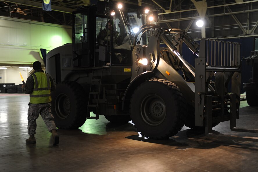 MISAWA AIR BASE, Japan – Airman 1st Class Christian Estanique, left, 35th Logistics Readiness Squadron, and Senior Airman Joseph Floeter, 35th Civil Engineer Squadron, move cargo during an operational readiness exercise here Nov. 6. The 35th Fighter Wing is preparing for an operational readiness inspection in December. (U.S. Air Force photo by Airman 1st Class Kia Atkins)
