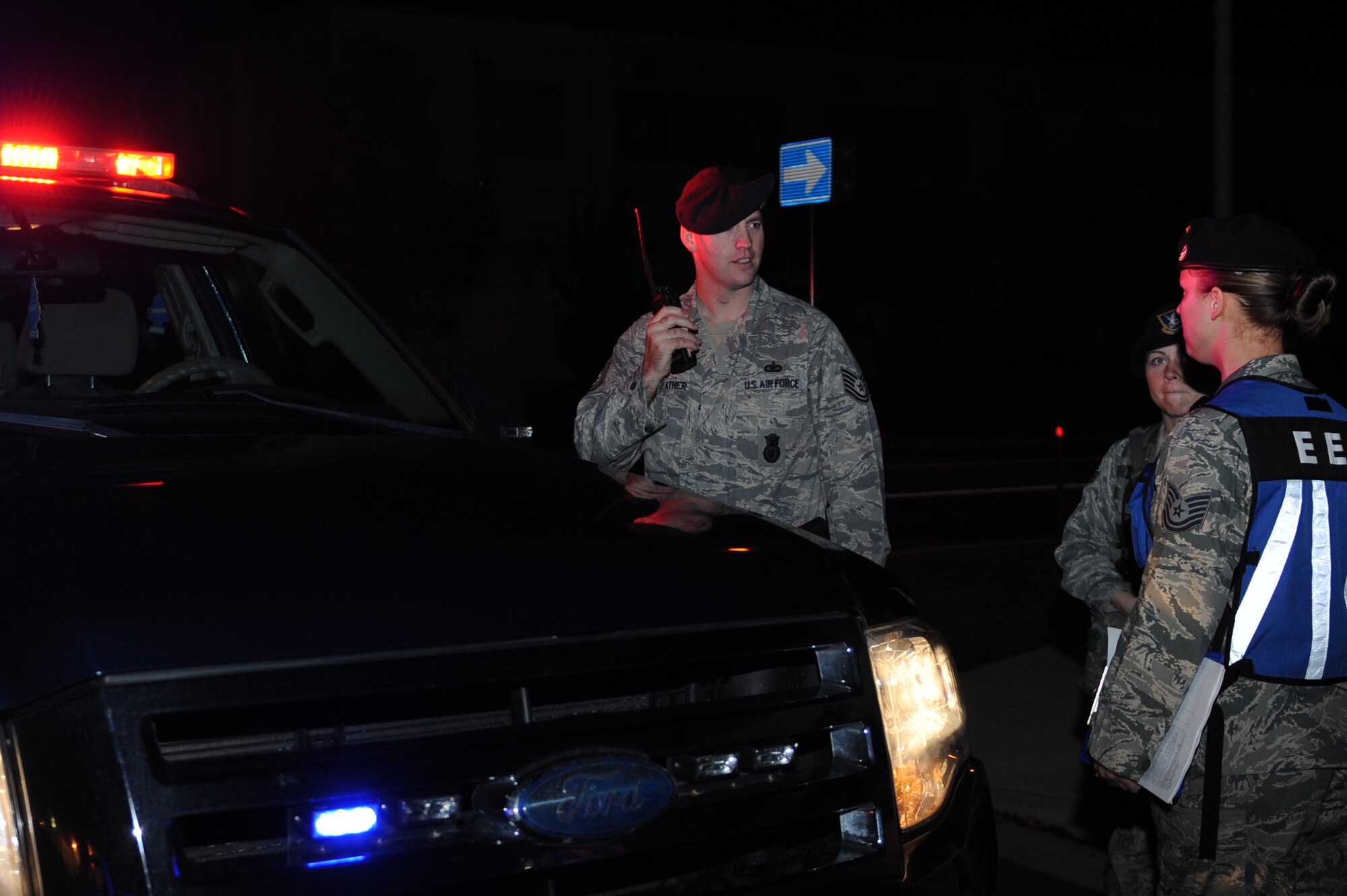 MISAWA AIR BASE, Japan – 35th Fighter Wing Security Forces Exercise Evaluation Team member Tech. Sgt. Sarah Aguilar questions Tech Sgt. Robert Starkweather, left, and Senior Airman Katelyn Farlow, all members of the 35th Security Forces Squadron, on the correct procedures for setting up a perimeter around a convenience store after a simulated robbery during an operational readiness exercise here Nov. 4. The 35th Fighter Wing is preparing for an operational readiness inspection in December. (U.S. Air Force photo by Airman 1st Class Kia Atkins) 