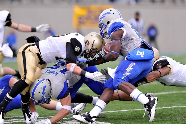 Air Force wide receiver Jonathan Warzeka blocks an Army defensive lineman for Falcons running back Asher Clark during the Air Force-Army game at Falcon Stadium Nov. 5, 2011. The Falcons scored 21 points in the third quarter en route to a 24-14 victory over the Black Knights and their second consecutive Commander-in-Chief's Trophy. (U.S. Air Force photo/Raymond McCoy)