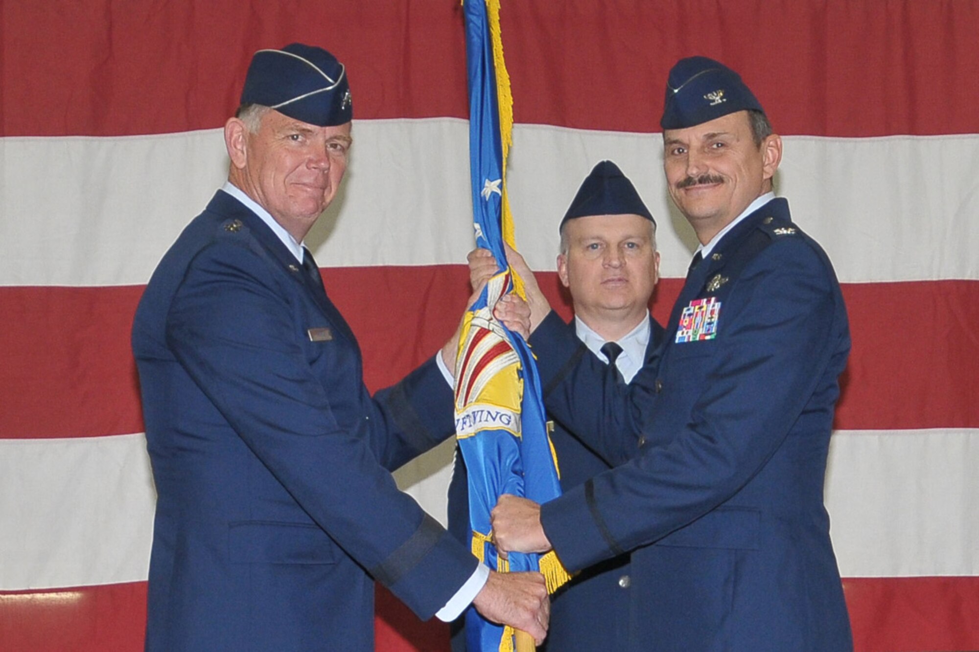 YOUNGSTOWN AIR RESERVE STATION, Ohio -- Maj. Gen. Wallace T. Ferris Jr. passes the 910th Airlift Wing guidon to Col. Reinhardt Schmidt at a change of command ceremony held here, Nov. 5, 2011. Col. Schmidt, whose last assignment was at Air Force Reserve Command, Robins Air Force base, Ga, succeeds outgoing commander, Col. Stephen J. "Fritz" Linsenmeyer Jr.. U.S. Air Force photo by Tech. Sgt. James L. Brock